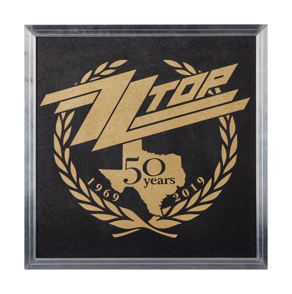 ZZ TOP | DUSTY HILL 50TH ANNIVERSARY GIFT: A custom stenciled presentation piece celebrating "ZZ Top / 50 Years / 1969 - 2019" made from the materials used to create road cases with Hafer Case plate on back. Hafer Case of Rosenberg,