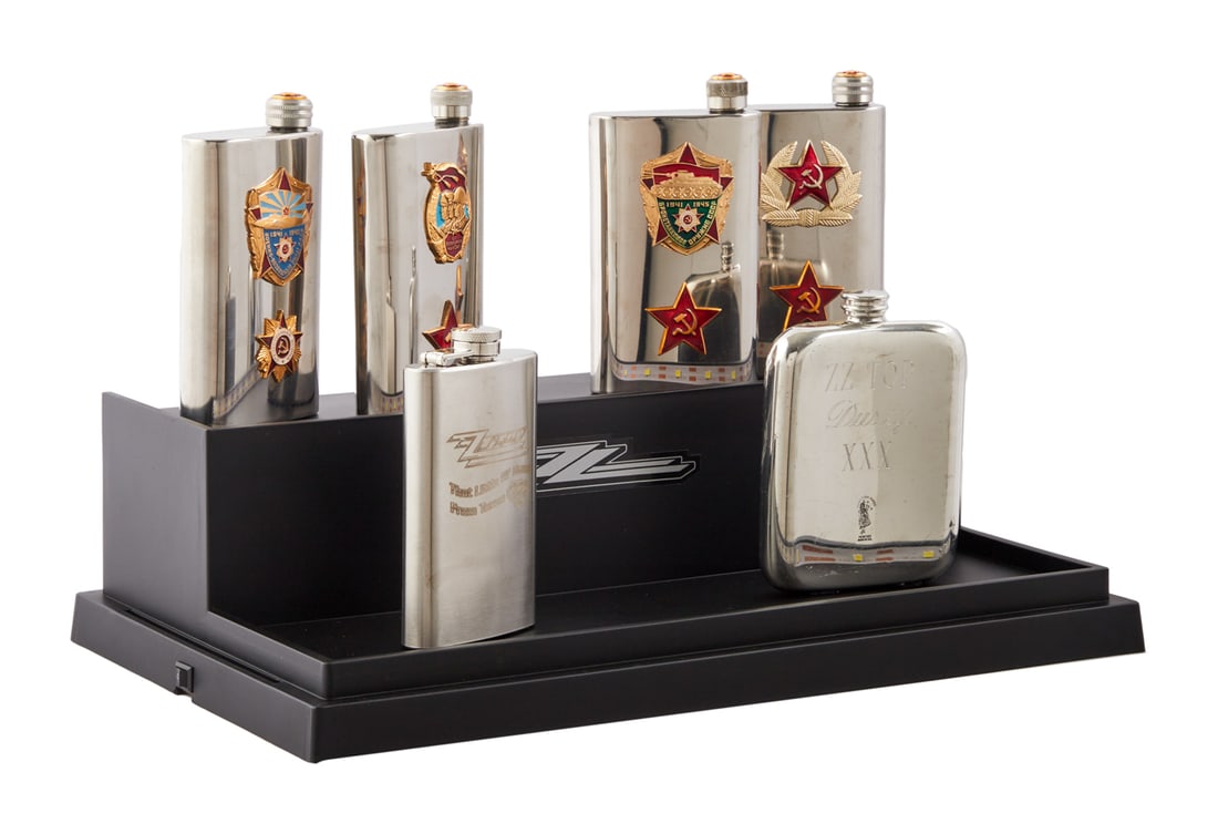 ZZ TOP | DUSTY HILL FLASK COLLECTION: A group of Four Soviet souvenir flasks in presentation case together with a ZZ Top "That Little Ol' Band From Texas" flask and a flask with Scottish thistle design custom engraved "
