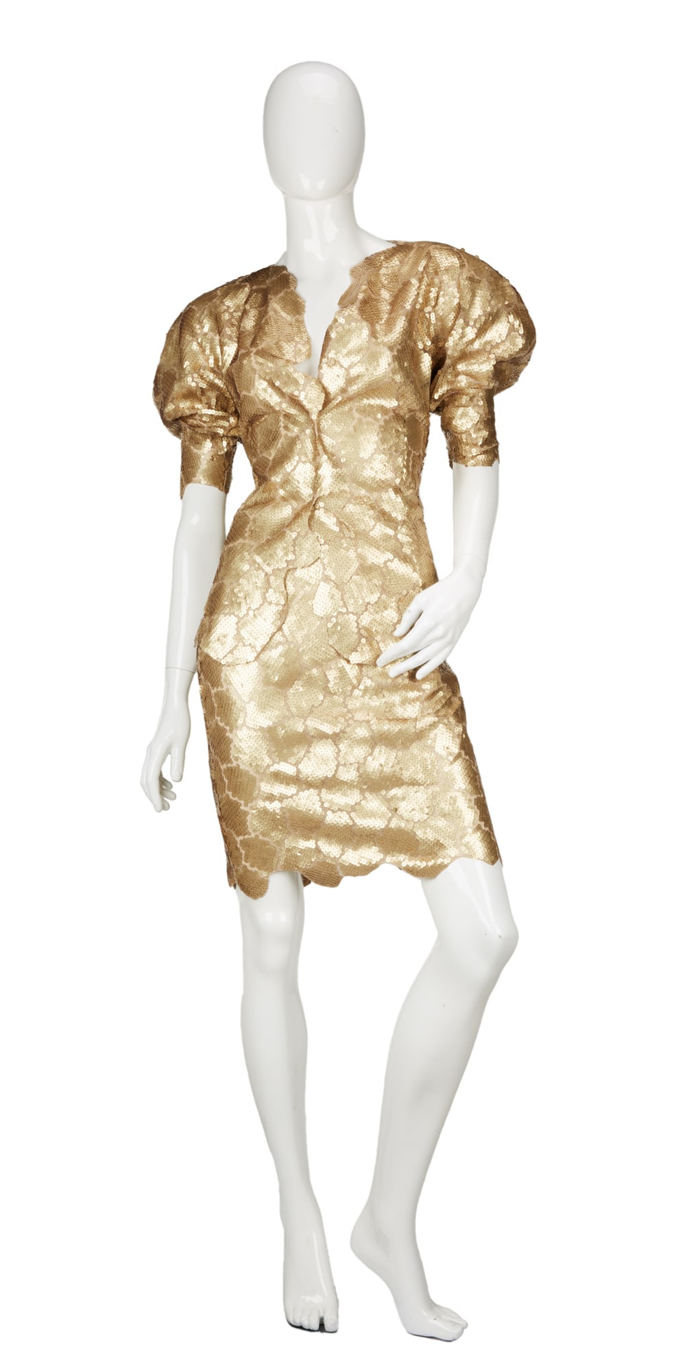 Krizia | Gold Sequin Skirt Suit: Lot 48: Krizia | Gold Sequin Skirt Suit A gold sequined skirt suit with a short-sleeve jacket and fitted pencil skirt designed by Italian ready-to-wear label Krizia. A gold sequin skirt suit wit