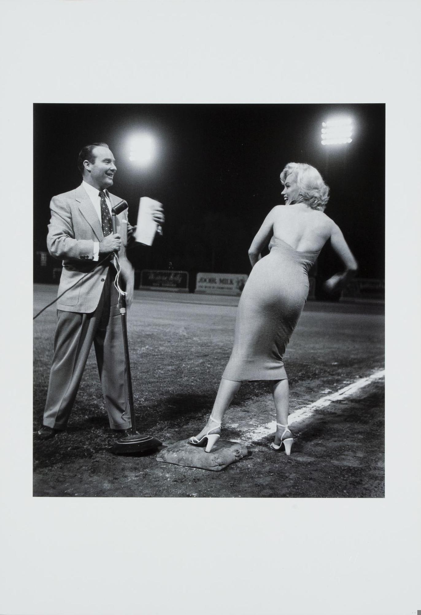 Marilyn Monroe | Frank Worth Limited Edition Baseball Field Photo: A 2000s-era print with a semi-gloss finish, depicting Marilyn Monroe with radio/TV host Ralph Edwards on a baseball field, circa 1952, posthumously estate-stamped in the lower right corner "Frank