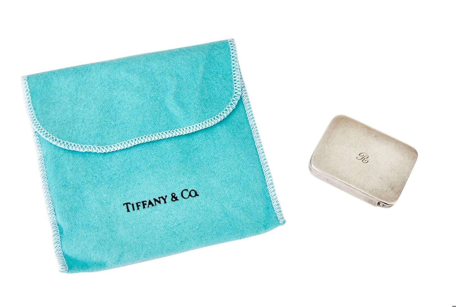 Raquel Welch | 'R' Monogrammed Tiffany & Co. Sterling Silver Pill Box: A sterling silver pill box retailed by Tiffany & Co. and manufactured by R. Blackinton & Co., the center of the lid with engraved monogram 'R', one end of the lid marked 'TIFFANY & CO.', one end of th