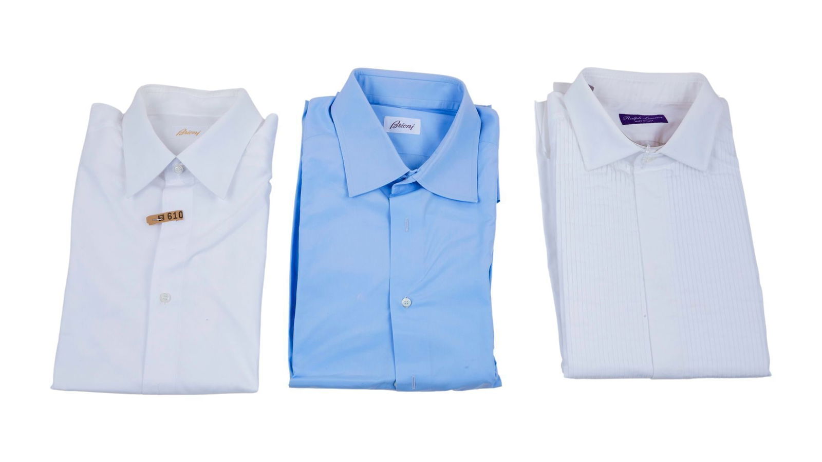 Tony Bennett | Dress Shirts: A trio of dress shirt that includes: a white cotton, pearlized buttons, labeled Brioni, no size present, with dry cleaning tag; a pale blue cotton labeled "Brioni" pearlized buttons, no size present,