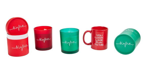 Kylie Minogue, OBE | Candles and Coffee Mug: A group of three items from the singer's London pop-up store; the first is a candle housed in a red canister with a lid, the second is a candle housed in a green canister with a lid, and the third is