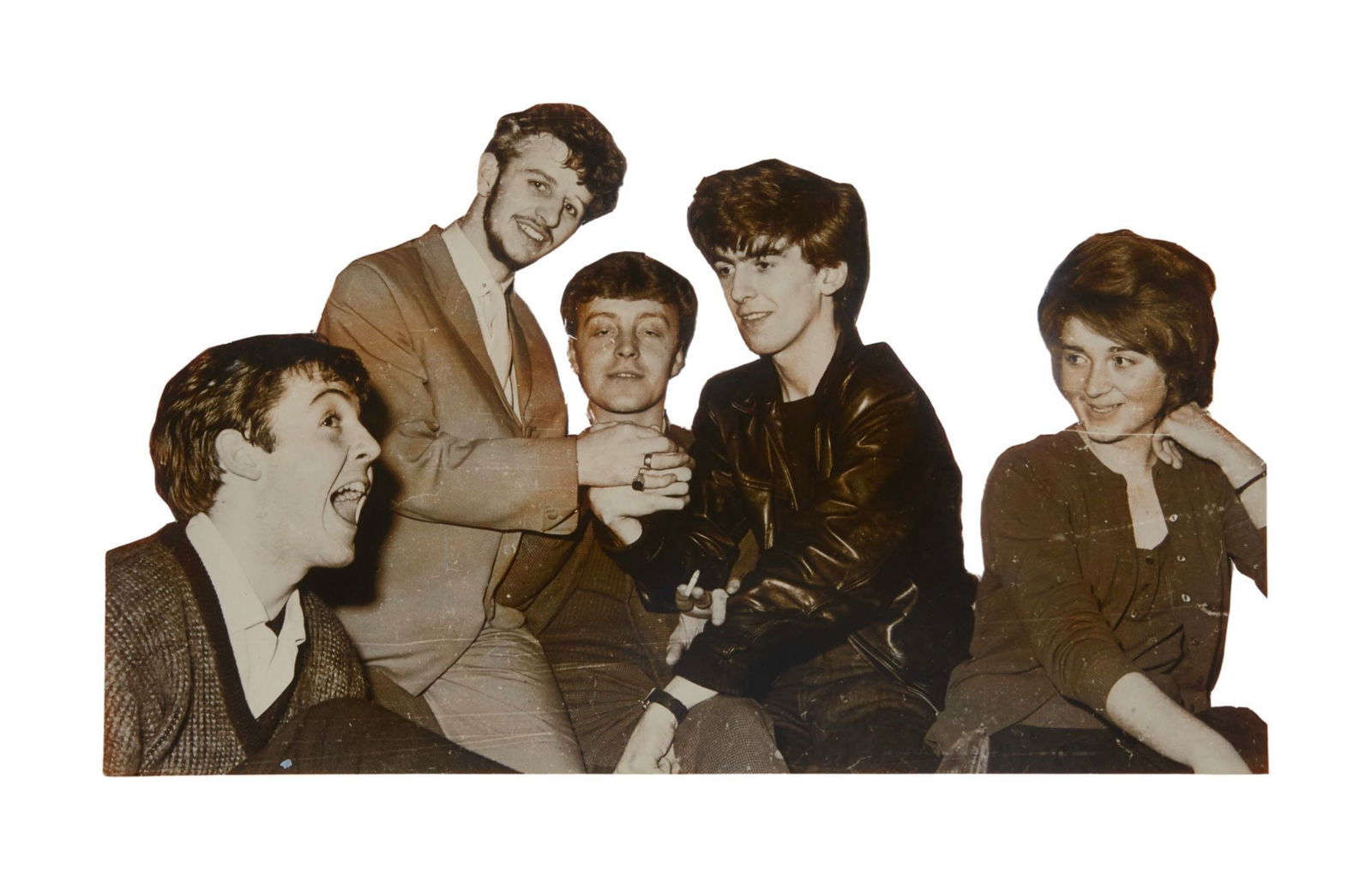 The Julian Lennon Collection | The Beatles Black and White Cut-Out Photo: A black and white cut out photograph of The Beatles, Paul McCartney, George Harrison, Ringo Starr and Pete Best (without John Lennon) together with female fan. 5.5 x 9.5 inches A portion of the sale p