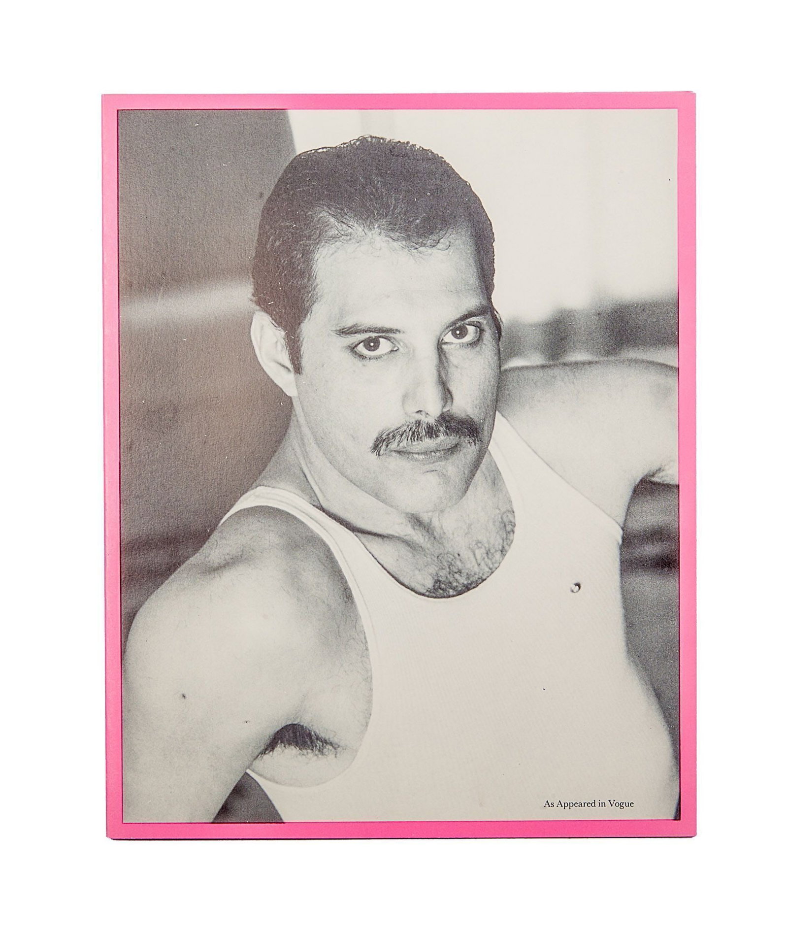 Queen | Freddie Mercury Owned "Posturing Old Tart" Christmas Card: A 1980s era pink Christmas card, featuring a black and white portrait of Freddie Mercury on the front, taken from a photo shoot for Vogue magazine. The greeting printed inside humorously reads, "Wishi