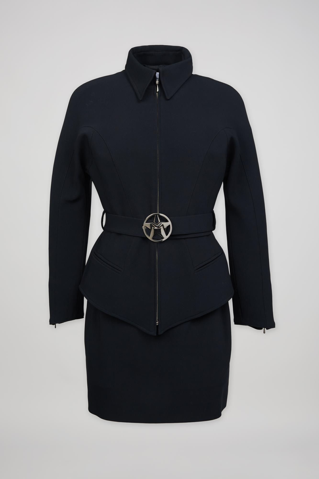 Thierry Mugler | 1990s Black Two-Piece Skirt Suit: Thierry Mugler skirt suit in black with a star belt from the 1990s. Rayon and polyamide blend with a slight stretch that has a similar feel to neoprene. The jacket has a zip front closure with a semi-