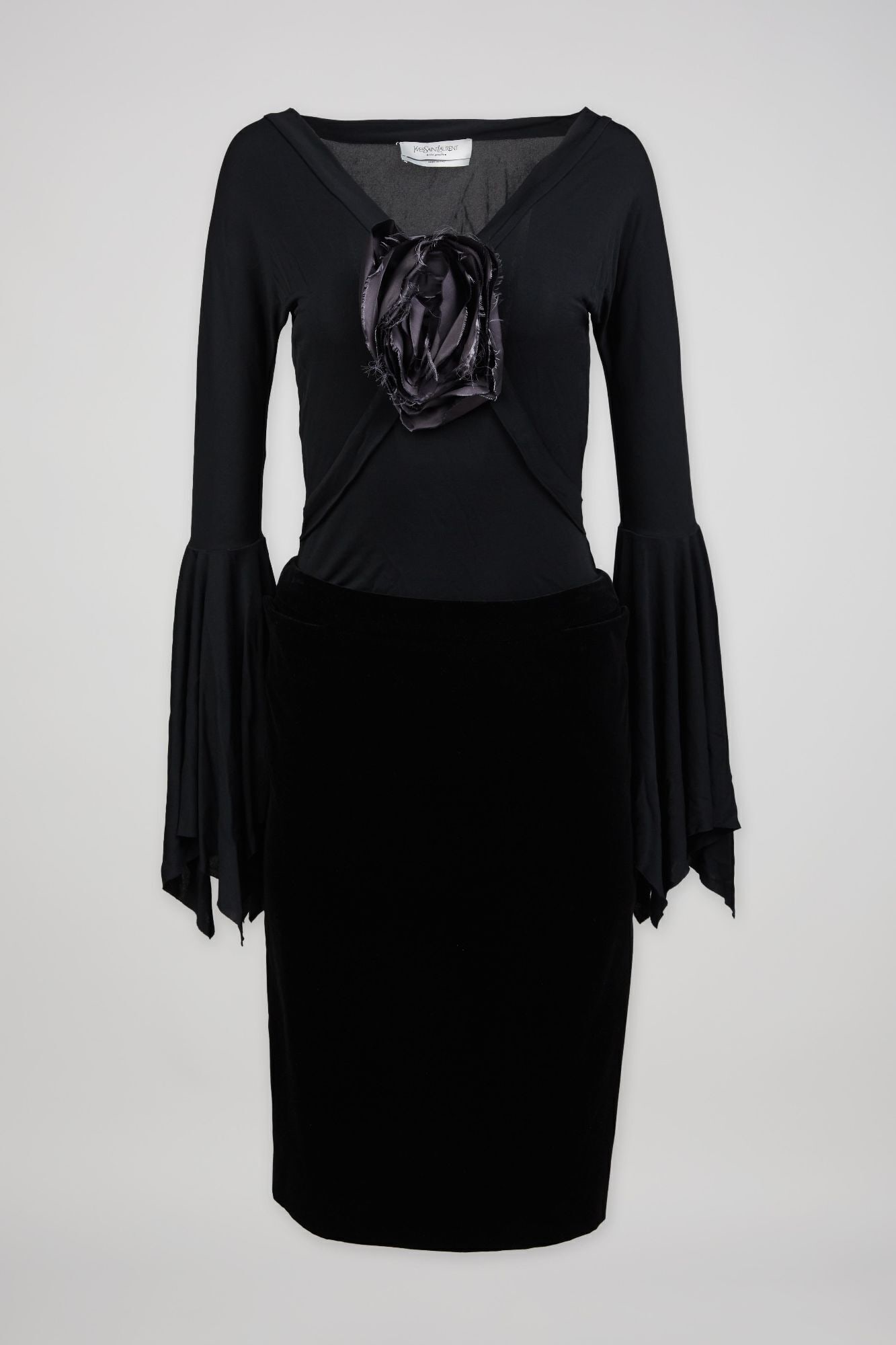 Yves Saint Laurent | Tom Ford Fall 2003 Evening Ensemble: A Yves Saint Laurent two-piece ensemble designed by Tom Ford for the fall 2003 ready-to-wear collection. The ensemble features a black matte jersey blouse with a low v-neck line (a silk flower tacked