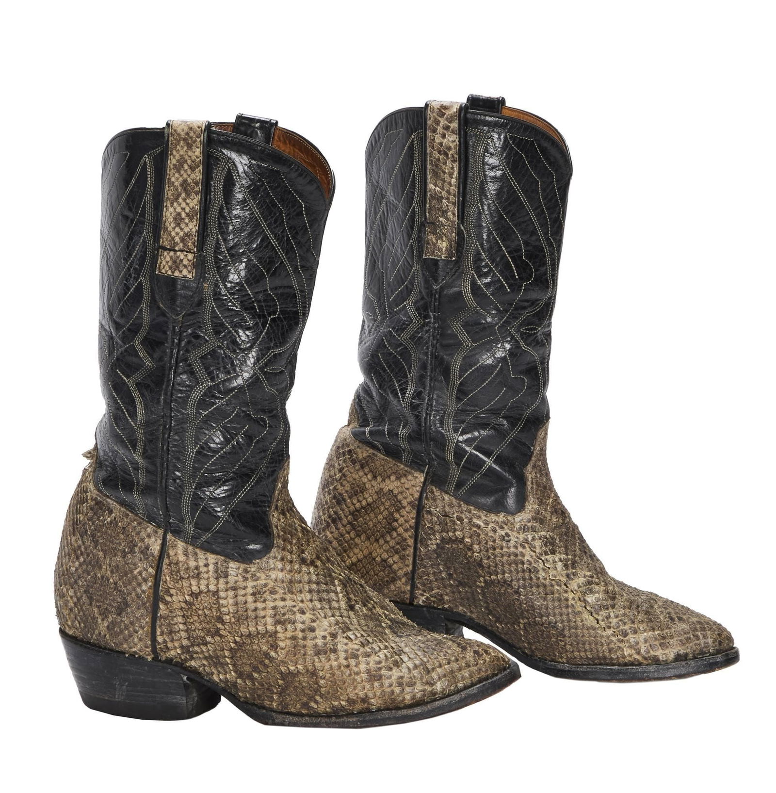 Burt Reynolds | Snakeskin Cowboy Boots: A pair of Manuel snakeskin boots with black leather upper, Cat's Paw neoprene sole heels, and fitted with DiFabrizio custom lift inserts. No size present. PROVENANCE From the Estate of Burt Reynolds B