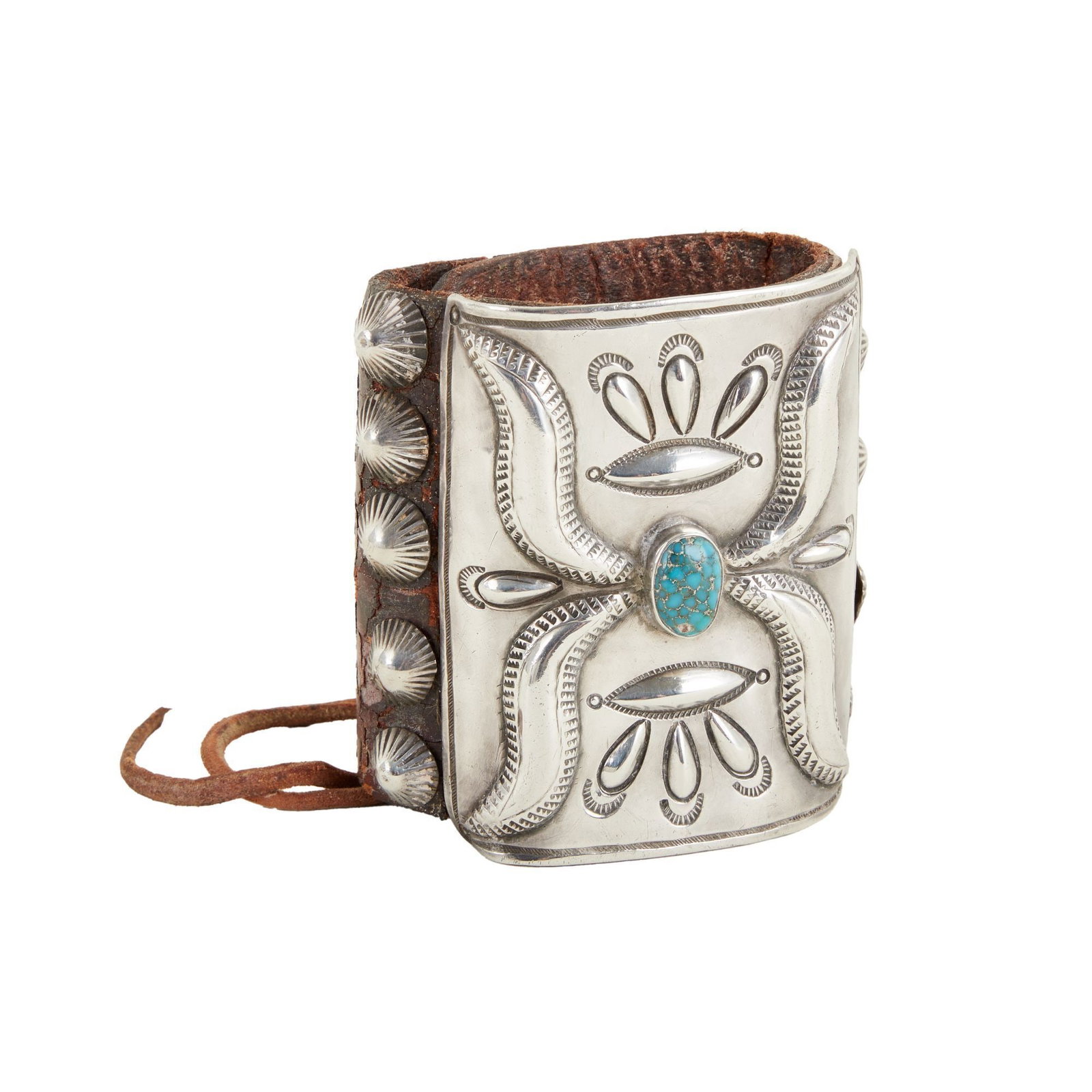 Burt Reynolds | Navajo Ketoh Bow Guard: A 1930s-era Navajo ketoh, or bow guard, owned by Burt Reynolds. The ketoh is comprised of brown leather, sterling silver, and a turquoise accent. Reynolds can be seen wearing ketohs similar in style a