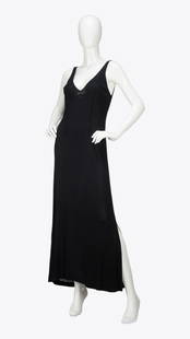 Elizabeth Taylor | Gown by Thea Porter: A black matte jersey evening dress designed by Thea Porter and owned by Elizabeth Taylor. A black matte jersey dress with a low-cut neckline that goes just past the bust, the gown features a fitted to
