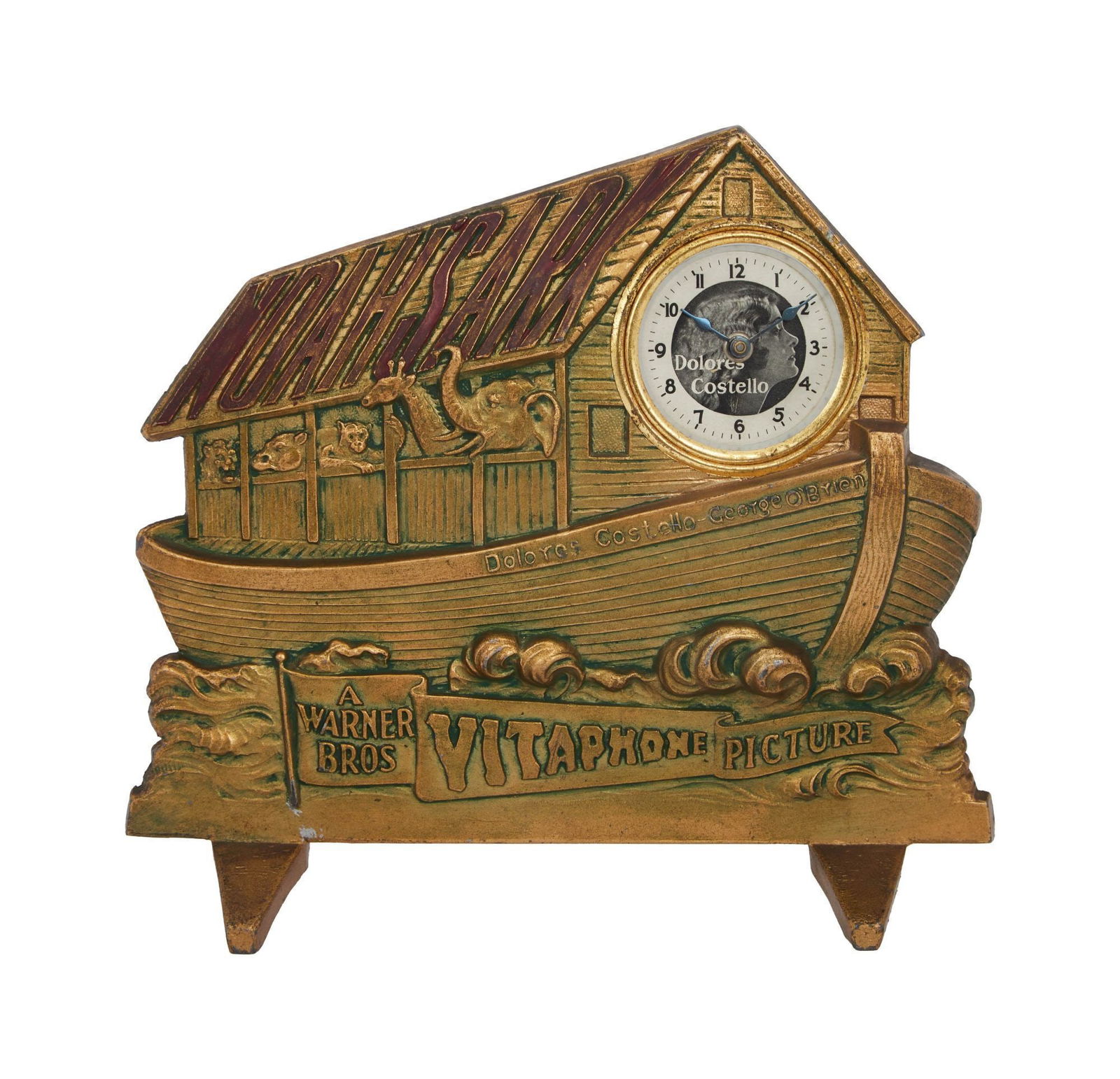 Noah's Ark | 1928 Promotional Clock: Warner Bros., 1928; an ornate piece, made of weighty brass, in the form of an ark with animals looking out to sea, text on front reads "Noah's Ark / Delores Costello George O'Brien / A / Warner Bros.