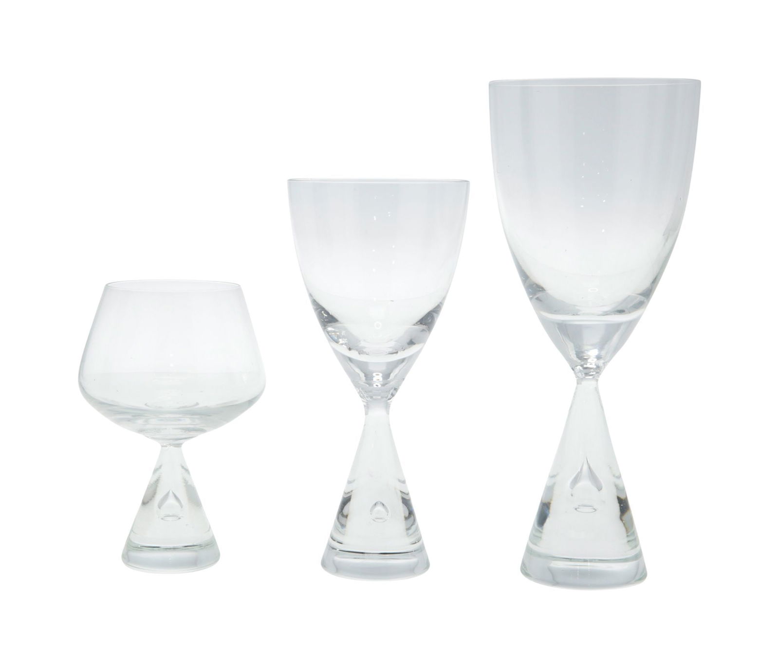 Playboy | Hugh Hefner Playboy Mansion Holmegaard Stemware in the Princess Pattern: A set of assorted Mid-century Modern Danish Kastrup Holmegaard glasses in the Princess pattern, including approximately 35 water glasses, 11 wine glasses, and 12 cordials. Designed by Bent Severin. La