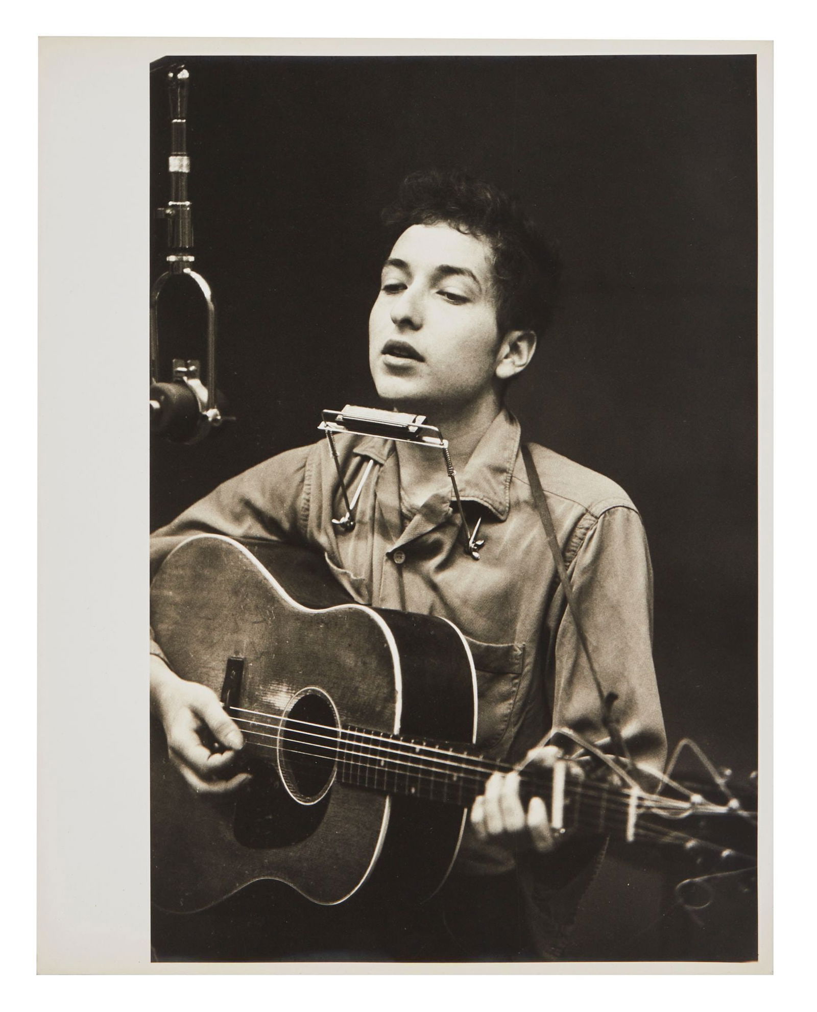 Bob Dylan | Large Vintage Photograph From 1961 Recording Session By Don Hunstein: A vintage 1960s photograph on archival paper of Bob Dylan in Columbia Records New York studio in November of 1961 recording his first eponymous album. Pencil notations on verso of image with a series
