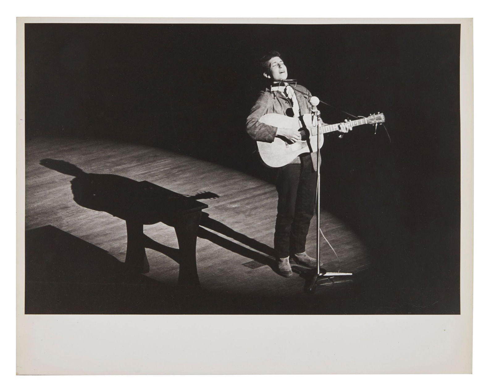 Bob Dylan | Large Vintage Associated Press Photograph From 1963: A vintage 1960s photograph on archival paper of Bob Dylan performing on stage, taken by an Associated Press agency photographer. Some sources indicate this image was taken during Dylan's historic firs