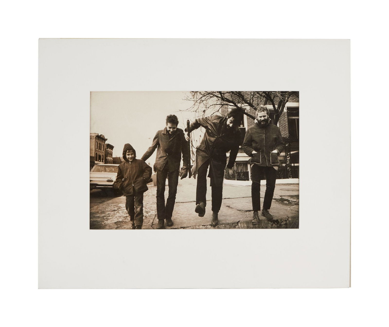 Bob Dylan | Large Vintage Photograph From Chicago 1963: A vintage silver gelatin photograph featuring Bob Dylan walking down the streets of Chicago. The stamp on verso "C Welles 12-31-63," dates the print to December of 1963 when Dylan was there to perform