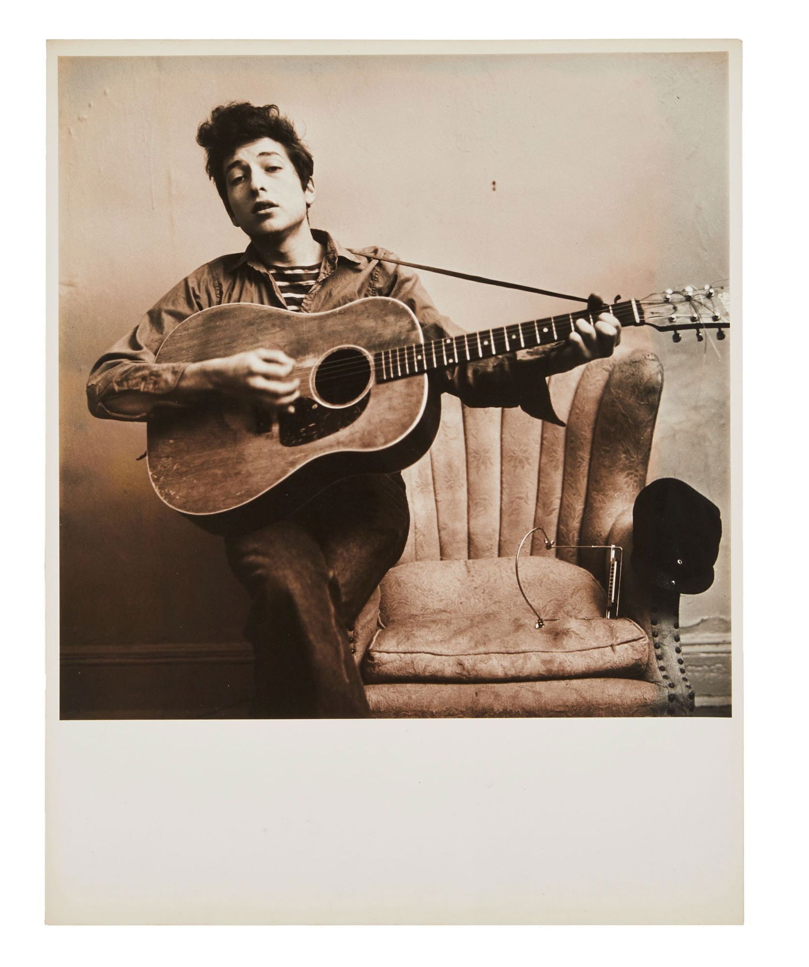 Bob Dylan | Large Vintage Photograph From Don Hunstein's 1963 Session: A vintage 1960s photograph on archival paper of Bob Dylan in his New York City apartment on West 4th Street. Pencil notations on verso of image with a series of numbers and letters likely film roll an