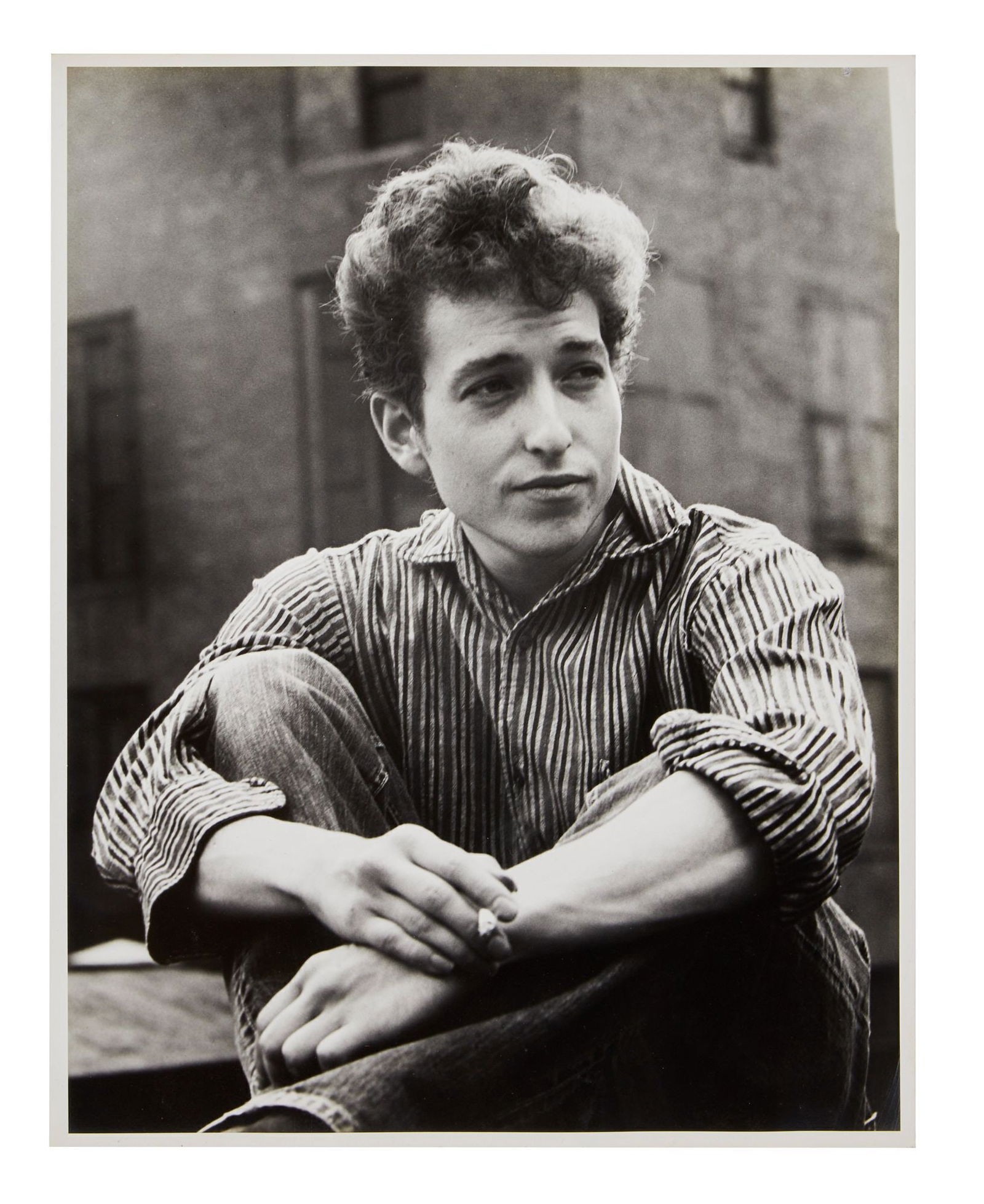 Bob Dylan | Large Vintage Photograph From 1963 Ralph Baxter Session: A vintage 1960s photograph on archival semi gloss photo paper of Bob Dylan in New York City shot by photographer Ralph Baxter. Photographer's stamp on verso reads, "Please Credit / Ralph Baxter / Adve