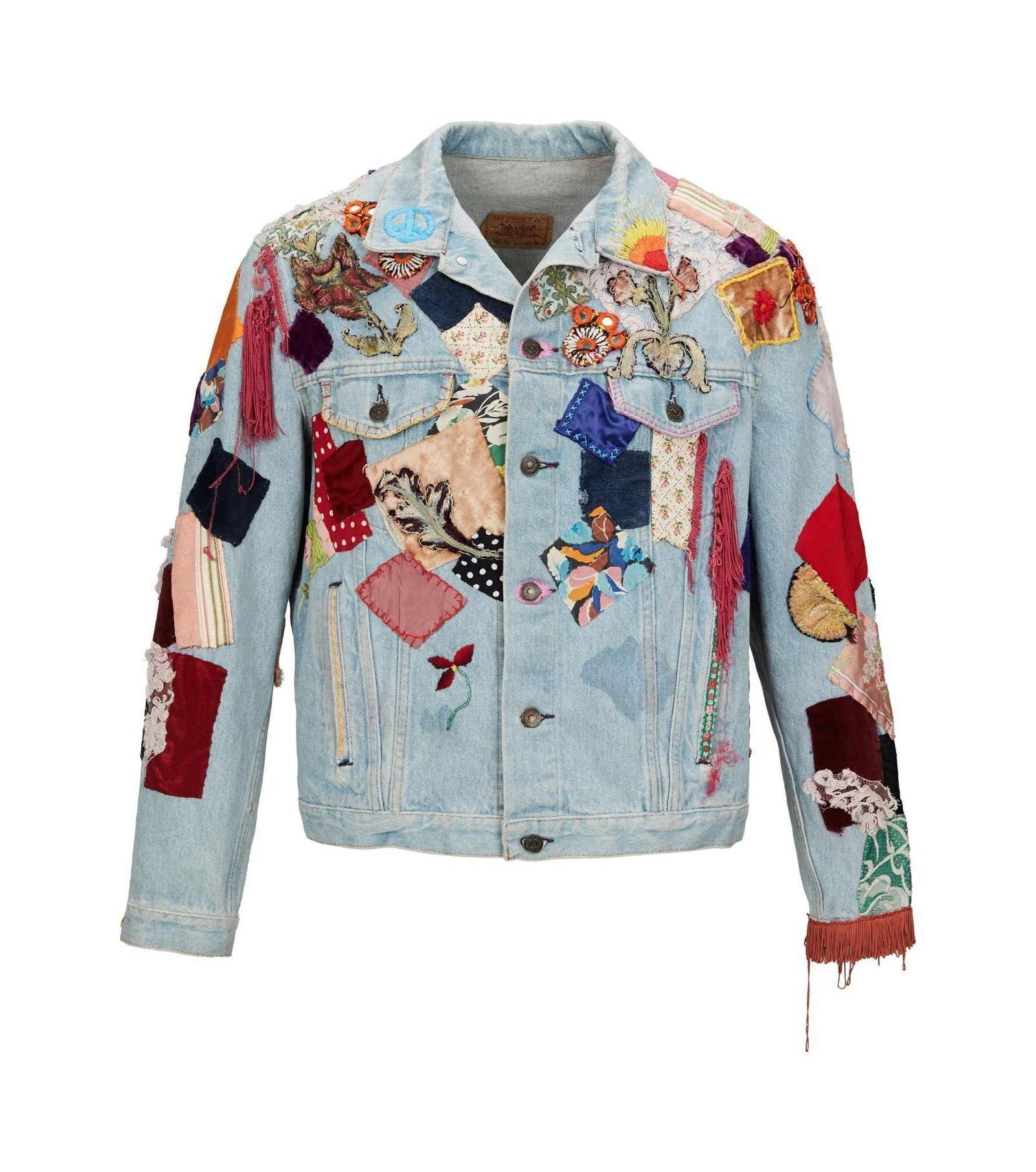 Bob Dylan | Screen Worn Patchwork Denim Jacket from 1987 Feature Film "Hearts of Fire": Levi's denim jacket hand embellished with velvet, lace and other textile patches worn by Bob Dylan in the feature film Hearts of Fire (Lorimar Motion Pictures, 1987). The jacket features hand embroide