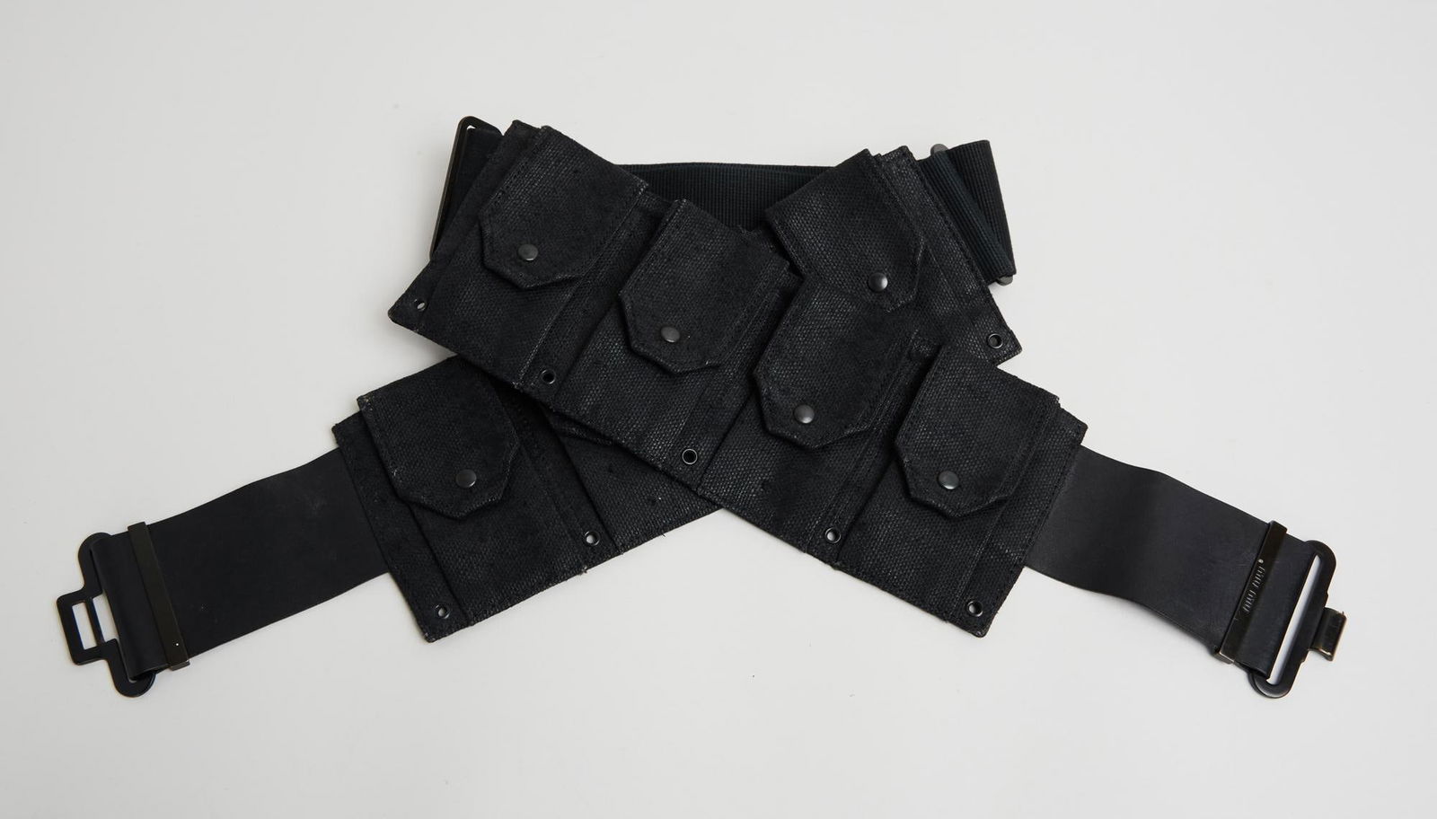 Miu Miu | Leather and Canvas Utility Belt: A Miu Miu black leather coated canvas utility belt made of web canvas with brass hardware and front hook clasp. For her spring 2001 runway show, Miuccia Prada featured belts with these specific hook-a