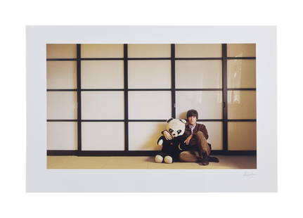 The Julian Lennon Collection | 1965 John Lennon Panda Photo Print by Robert Freeman: A color photographic print of John Lennon with giant stuffed panda, c 1965, taken by photographer Robert Freeman. Signed on the bottom right by Freeman in pencil. Robert Freeman is best known fo