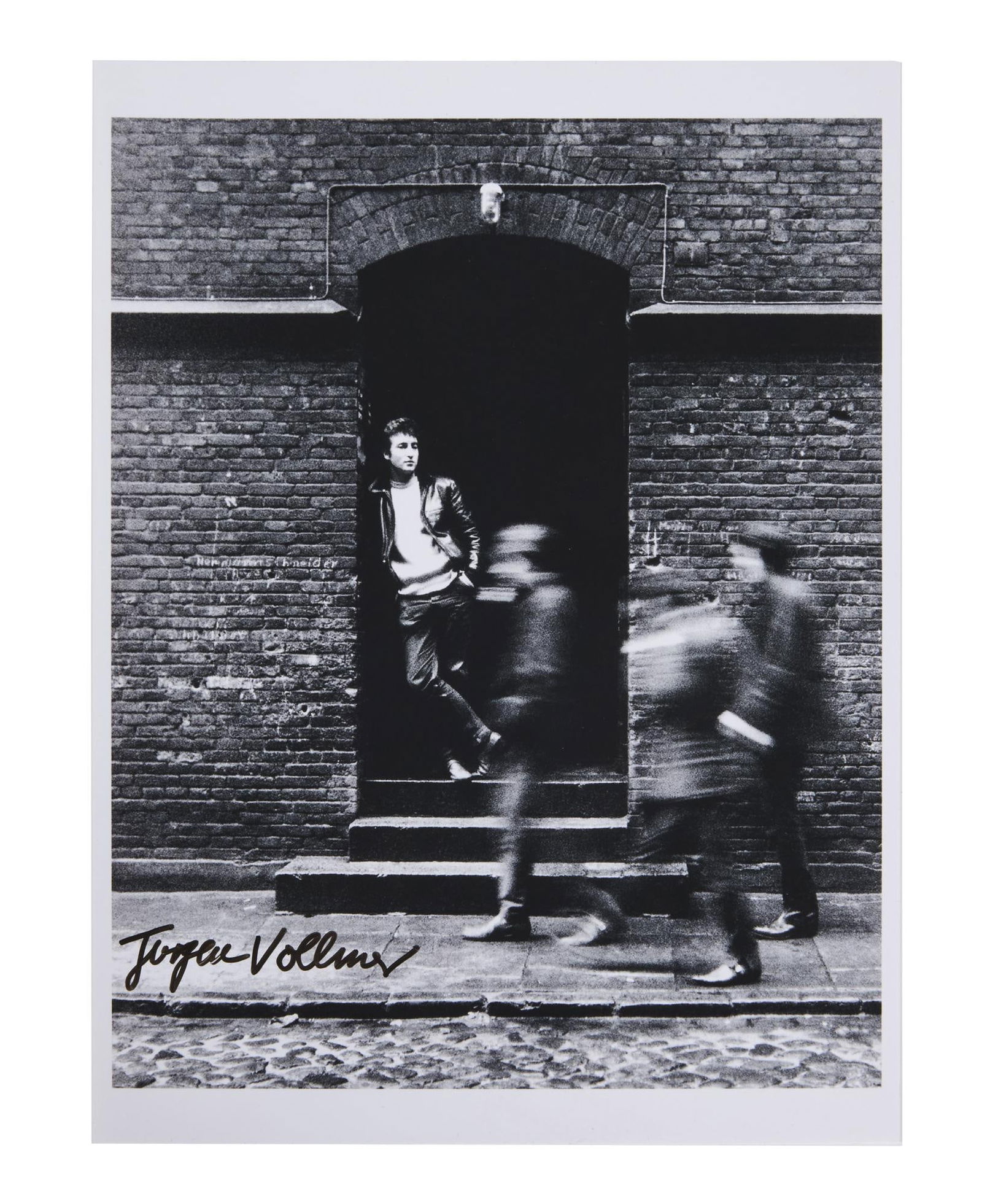 The Beatles | 1961 John Lennon Print Signed By Jurgen Vollmer: A modern black and white photo print of John Lennon, taken in Hamburg, Germany in 1961 by photographer Jurgen Vollmer. The photograph was taken sometime between April 1 - July 1, 1961, when The Beatle