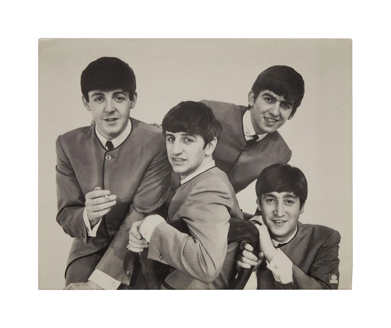 The Beatles | 1963 Dezo Hoffmann Merchandising Photo: An oversized vintage 1960s black and white merchandising photograph featuring The Beatles in their famous grey collarless suits, taken in April of 1963 at Dezo Hoffman’s studio on Wardour Street