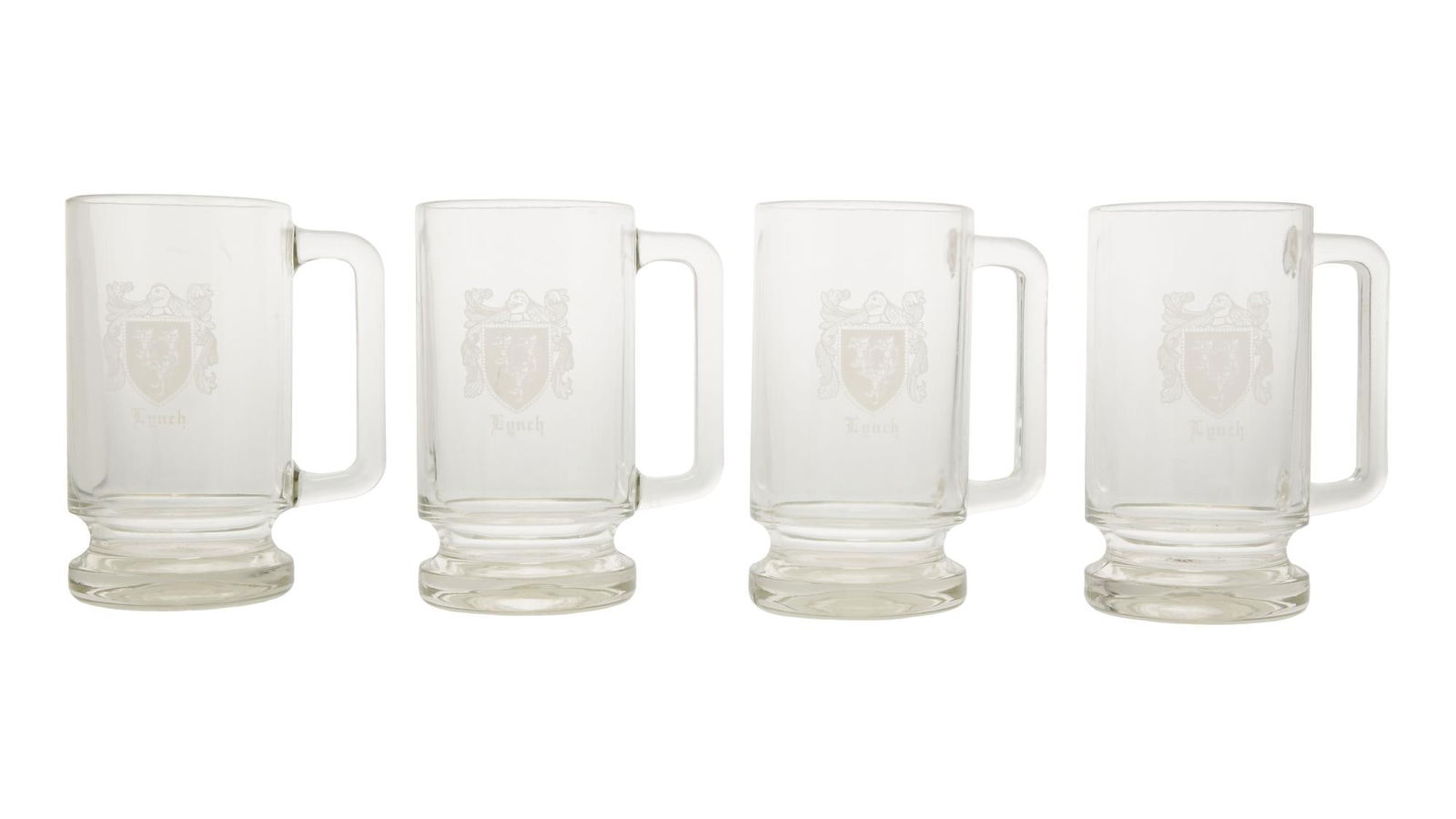 David Lynch | Lynch Family Coat of Arms Mugs with Magnet: Four glass mugs featuring the Lynch Family Coat of Arms. The Coat of Arms is faded on some of the mugs and there is slight general wear throughout all four, but overall in good condition. Together wit