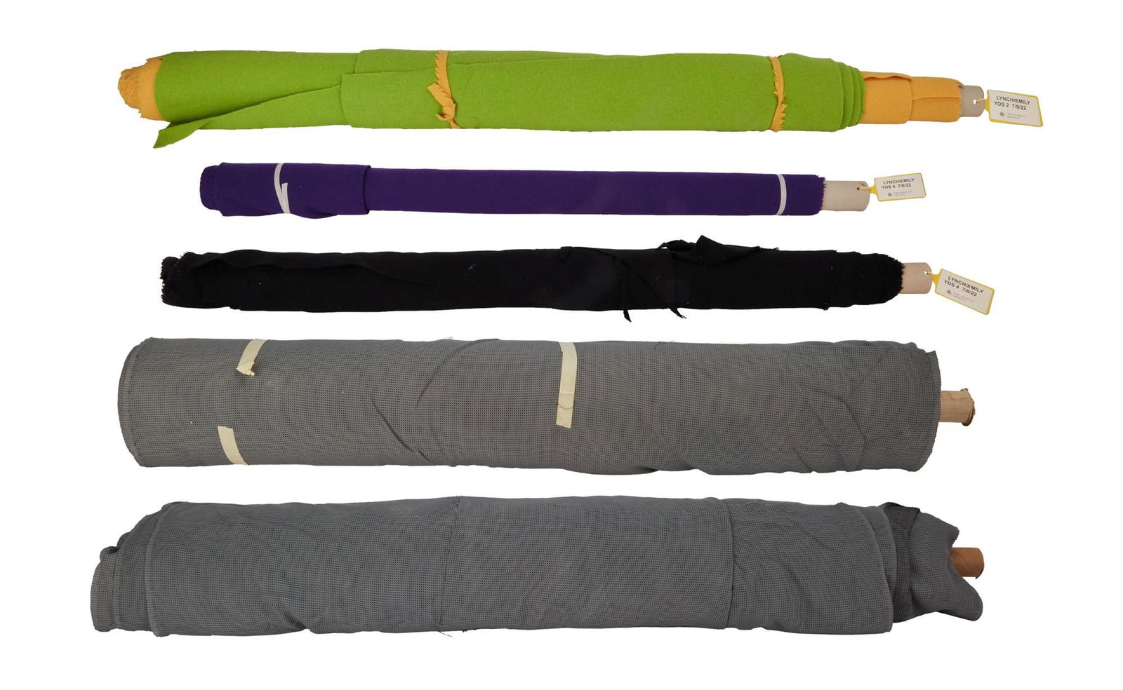 David Lynch | Fabric Reams and Yardages: Two reams of fabric and three fabric yardages. The reams are each gray waffle knit. The yardages are believed to be cotton or wool-blend, potentially for furniture upholstery, in purple, black, and gr