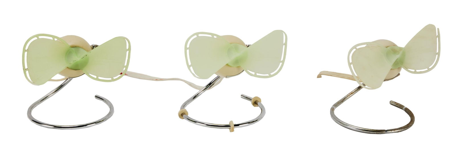 David Lynch | Vintage-Inspired Personal Mini Fans: A group of three; all similar with the propellers in shades of mint green affixed to a silver-tone metal circular base, with a label reading in part "Dragonfly / Circa 1958" and "Made i