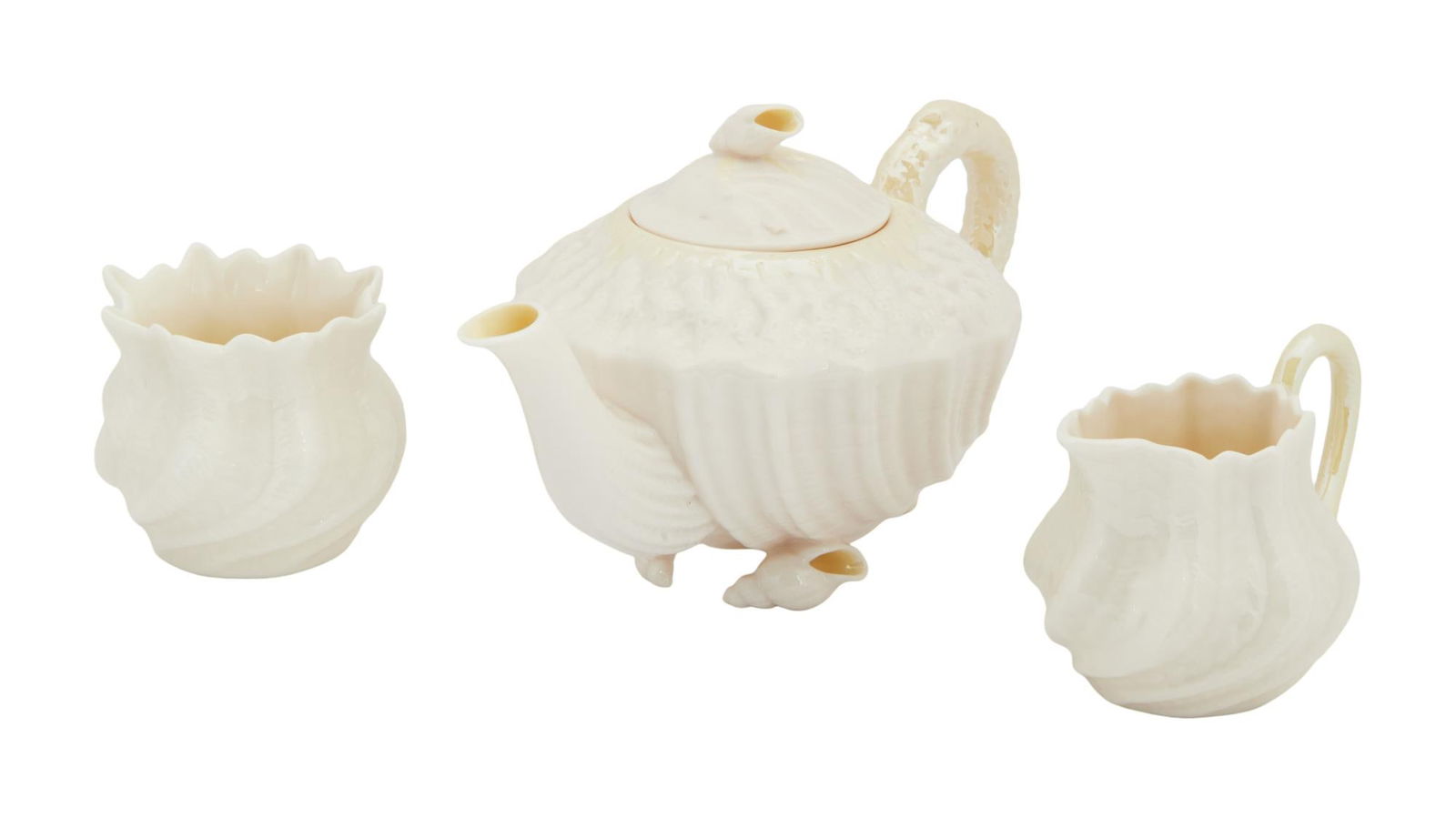 David Lynch | Belleek Pieces: A group of three; the first a teapot with a pretty seashell motif; the second and third a creamer and sugar set; all marked on the bottom in part "Belleek / Ireland." A group of three; the f