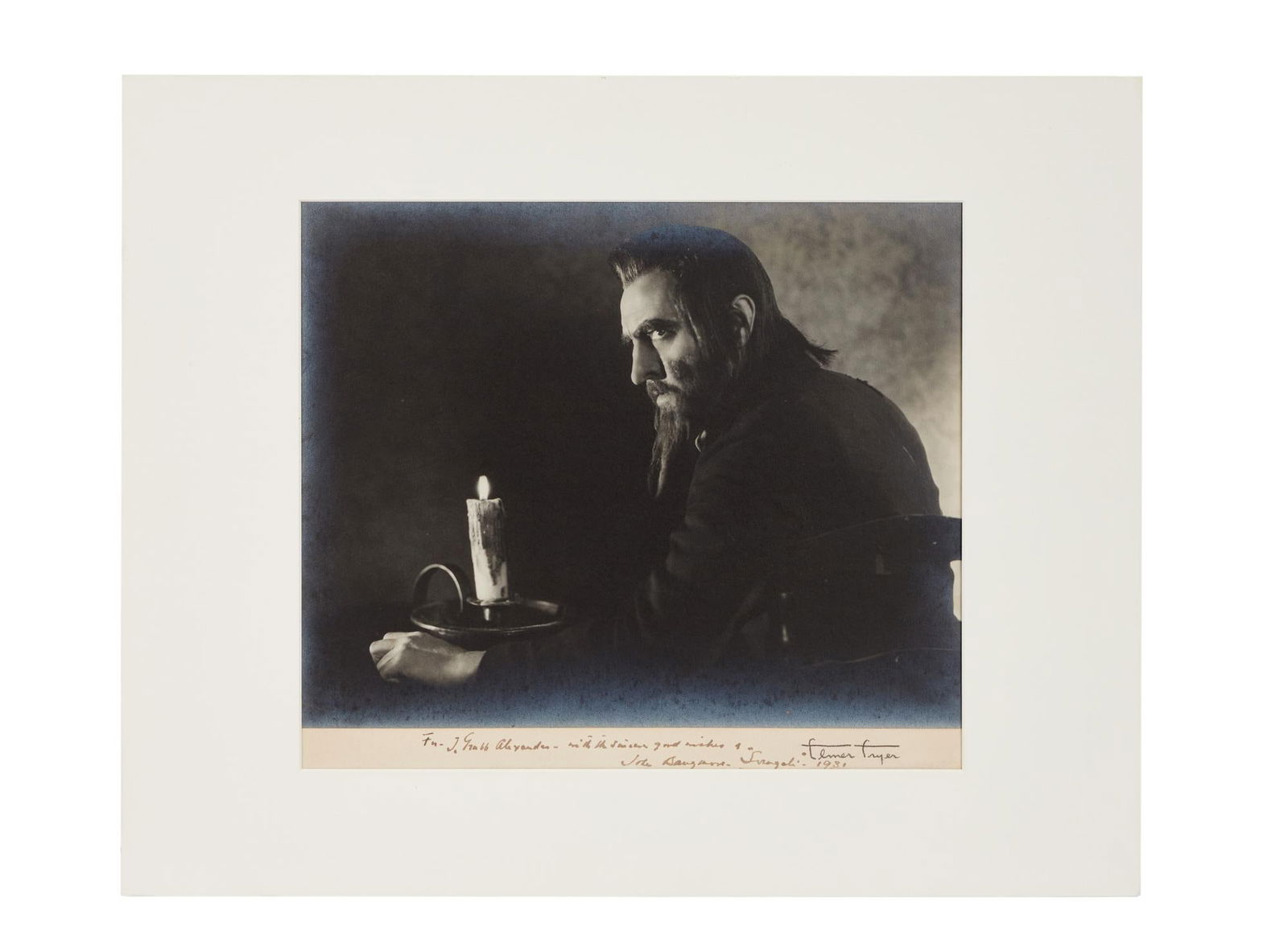 John Barrymore | 1931 Signed Black and White Photograph by Elmer Fryer: An original print; matte finish, large format, mounted to board, depicting the actor in costume, signed in black fountain pen ink on the lower mat board "For J. Grubb Alexander - with the sincere