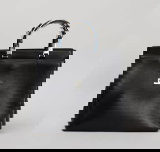Princess Diana | Versace Black Leather Bag: A Versace leather with silver-tone metal top handles belonging to Diana, Princess of Wales, circa 1997. This structured leather tote features a front flap pocket with a silver Medusa head at the