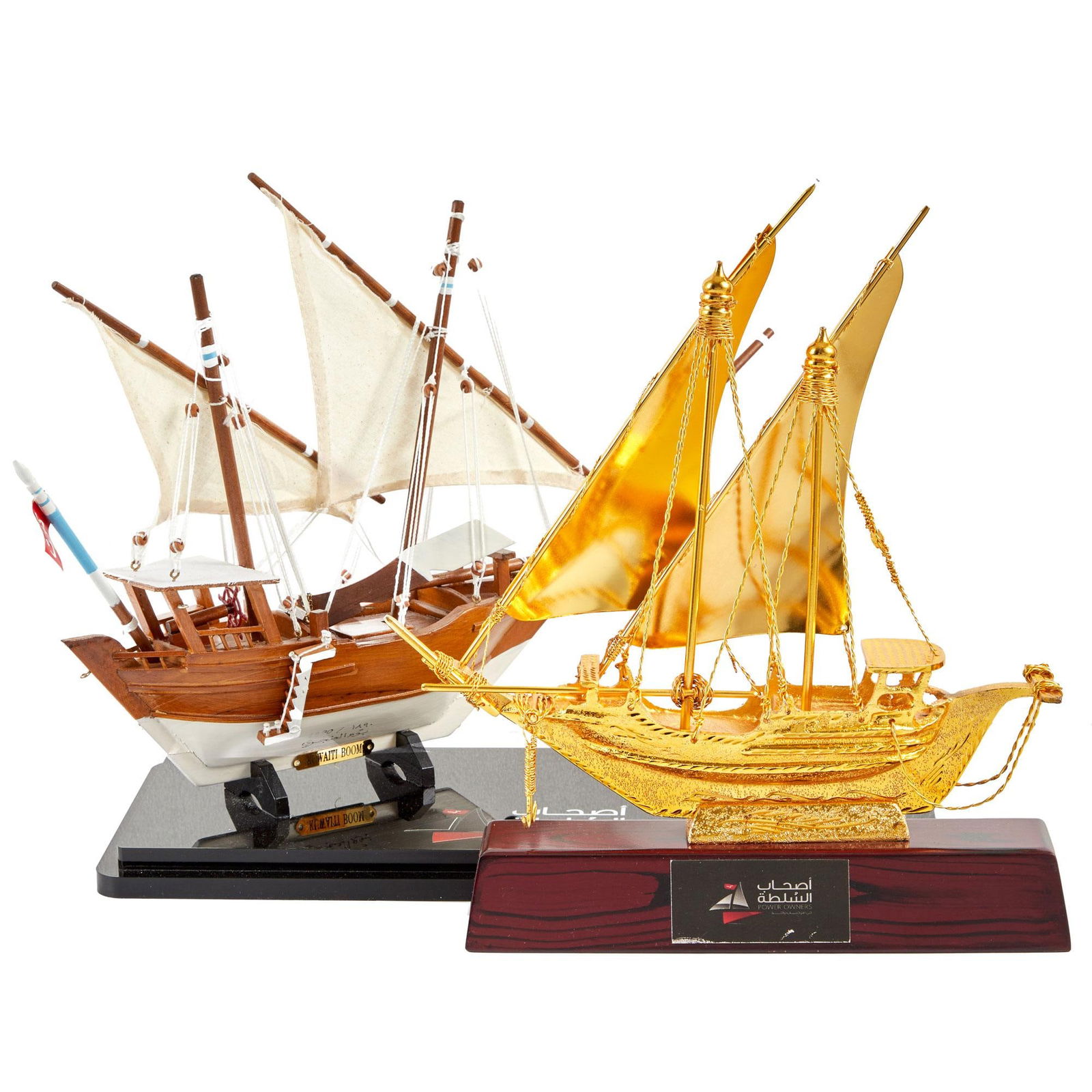 Larry King | 2000s Small Ship Models: A group of two; the first made of wood and canvas, affixed to a black resin base; the second made of gold-tone metal, affixed to a wooden base; both with text on bases reading in part "Power Owne