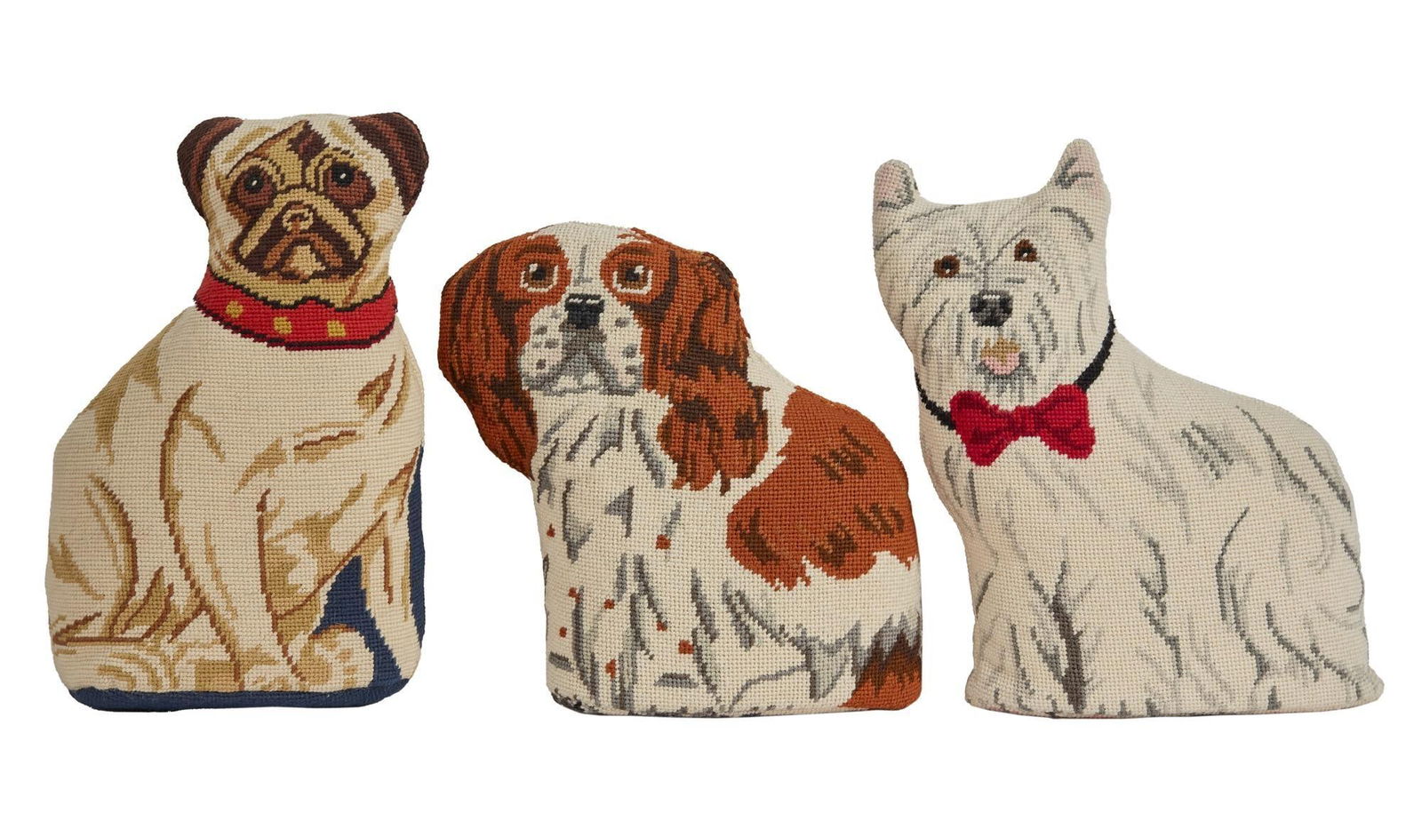 Joan Rivers | Three Dog Pillow Door Stops Seen In "A Piece of Work" with Book: A group of three needlepoint pillow doorstops modeled after small dogs, a King Charles spaniel, a pug, and a terrier. Many needlepoint pillows featuring dogs or funny messages decorated Joan Rive
