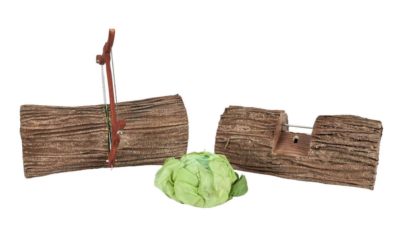 The Tale of the Bunny Picnic | See-Saw and Hacksaw Logs with Lettuce Head Prop and Storybook: Two prop logs from the production of the television special The Tale of the Bunny Picnic (HBO, 1986). One log contains a hacksaw embedded in its center and a thick, metal rod protruding out