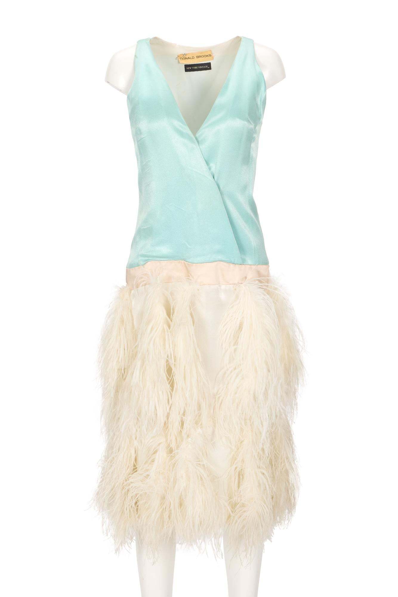 Lady Gaga | 2015 Shiseido Campaign-Worn Donald Brooks Dress: A Donal Brooks blue satin and ostrich feather dress, worn by Lady Gaga in a video for her 2015 "Be Yourself" campaign with Shiseido. The dress features a 1920s-style silhouette with a wrap n