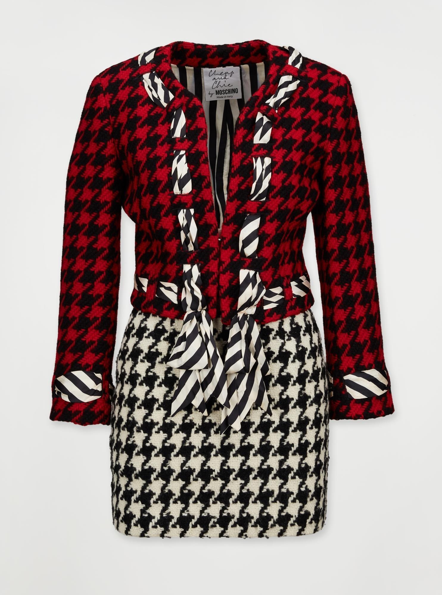 Moschino | 1990 Cheap & Chic Houndstooth Suit: This is a Franco Moschino two-piece houndstooth skirt suit with a woven striped fabric detail that outlines the edge of the jacket. This specific design was made famous by Princess Diana, who wore a s