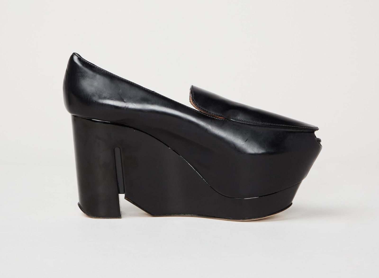 Calvin Klein Collection | Francisco Costa Black Runway Platforms: A pair of black leather Calvin Klein Collection platforms with peep-toe, designed during Francisco Costa's tenure as creative director. The sleek design combines a platform with a loafer. The loaf