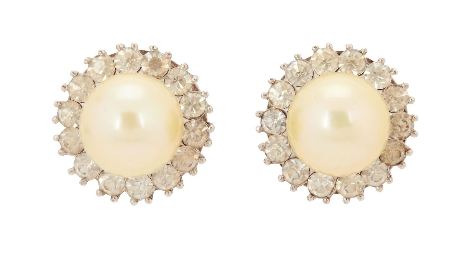 Joan Collins et al. | Earrings from "Dynasty": ABC Television, 1981-1989; a c. 1940s vintage pair made of rhinestones in a circular pattern with one large faux pearl in the center, in a silverplate metal setting, clipbacks; worn by the star in the