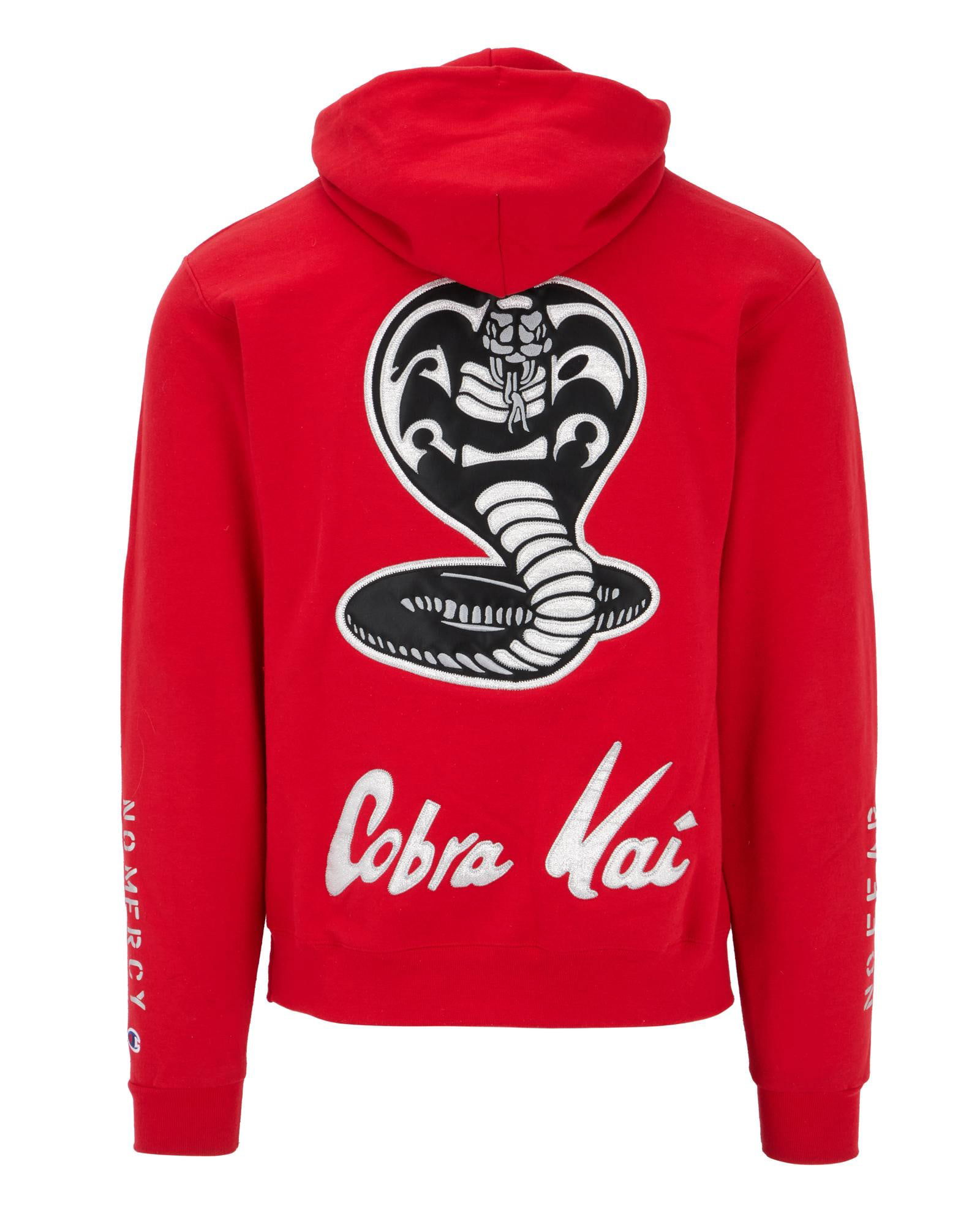 Cobra Kai | Champion Hoodie: A vivid red pullover hoodie from the production of the Emmy-nominated television series Cobra Kai (YouTube/Netflix, 2018-2025). The front of the hoodie features a Champion logo in the upper left, with