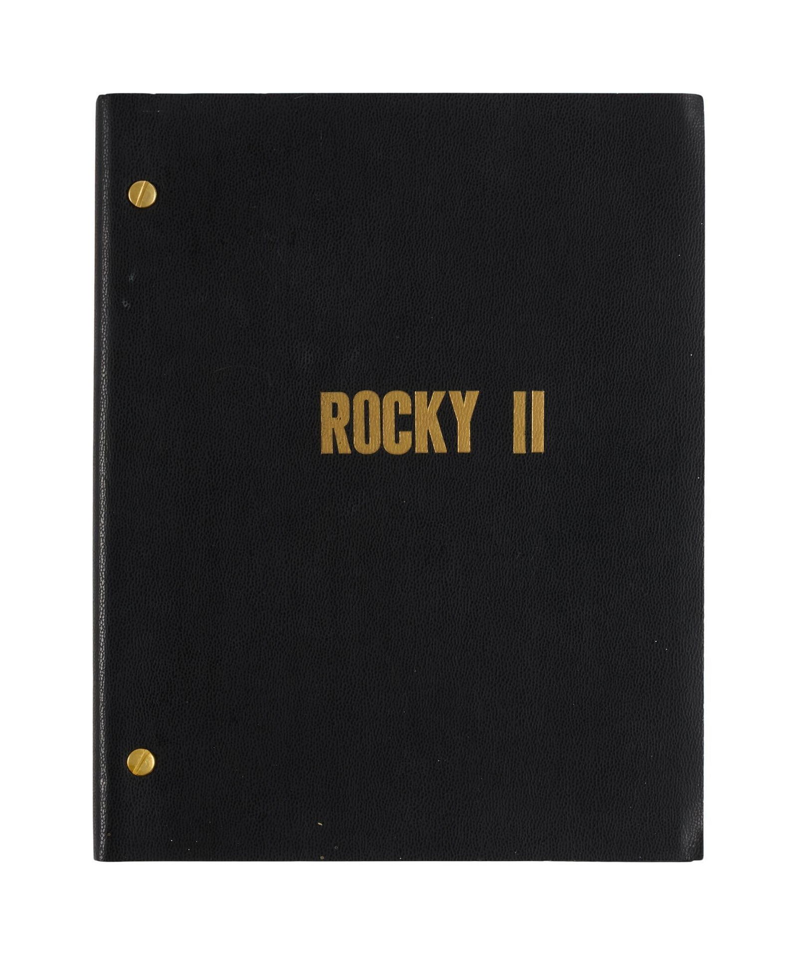Rocky II | Production Script: An original production script for Rocky II (United Artists, 1979) by Sylvester Stallone, under the title Rocky II: Redemption. The script is housed in a faux-leather cover with the