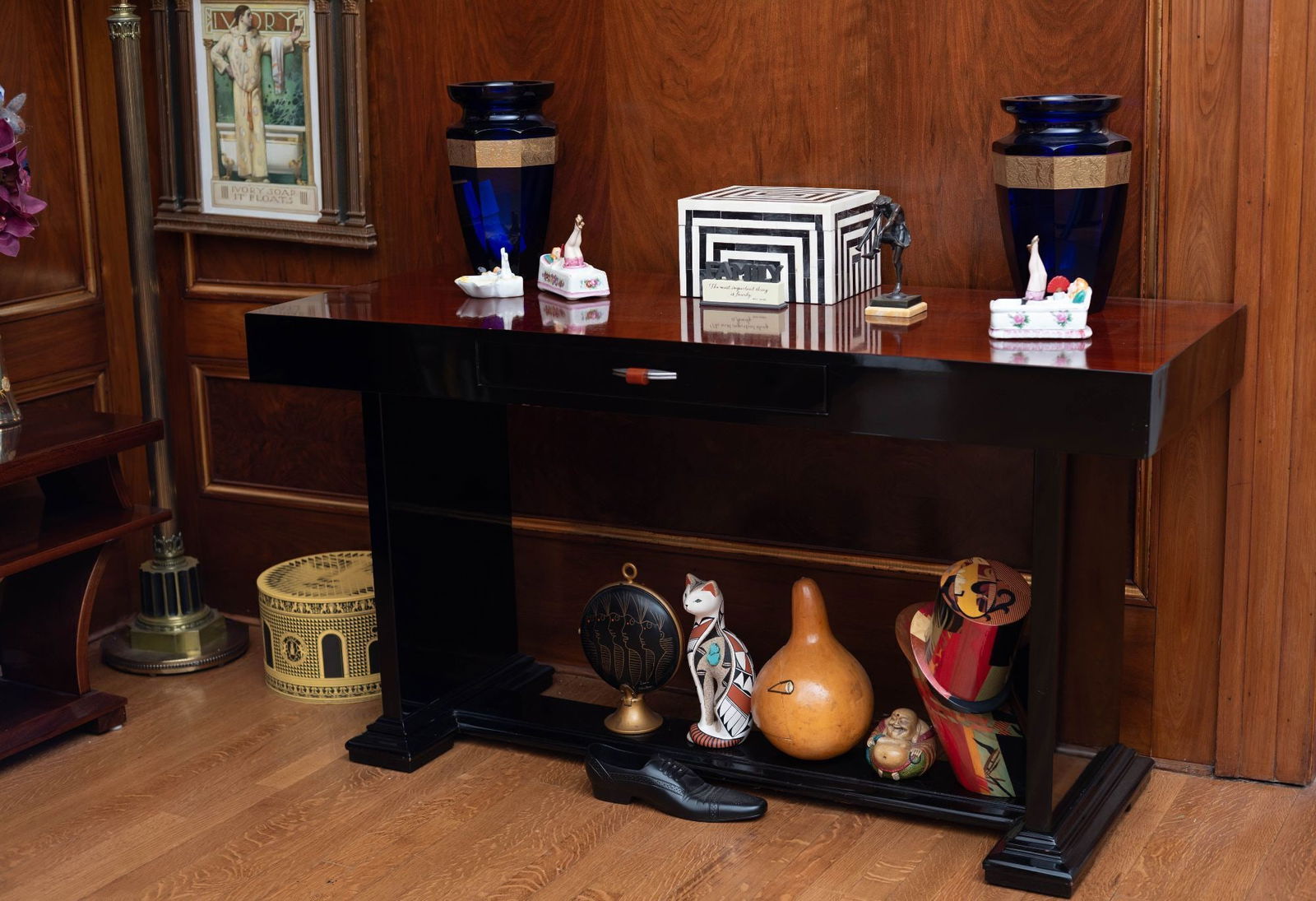 Whoopi Goldberg | Art Deco Console Table with Bakelite Handle: A 1930s Art Deco part ebonized console table with a frieze drawer, fronted by a carnelian colored bakelite handle. 30.75 x 57 x 22.5 inches From the Collection of Whoopi Goldberg
