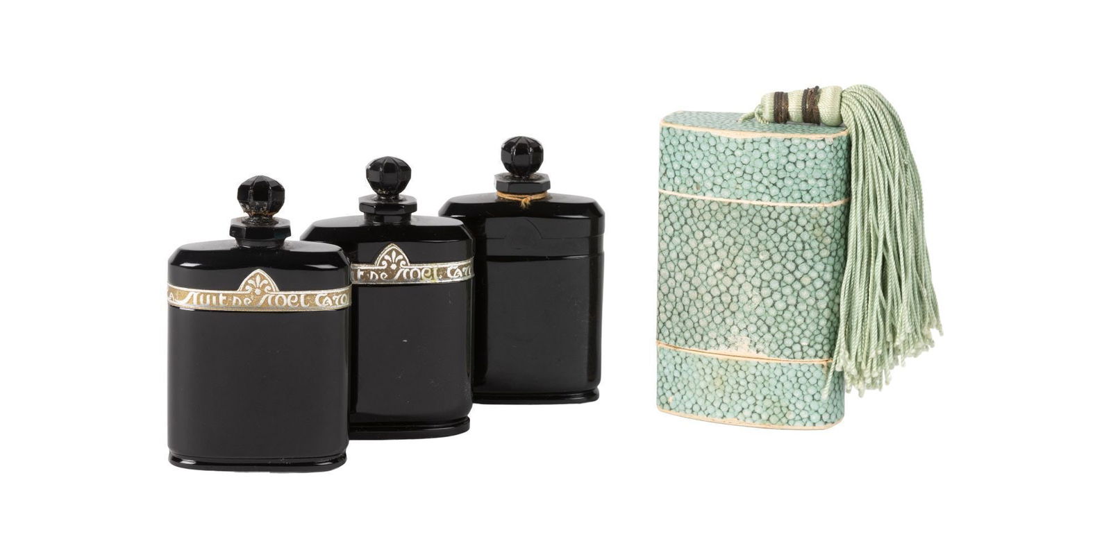 Whoopi Goldberg | Three Baccarat Caron La Nuit de Noel Bottles: A group of three Baccarat "Caron La Nuit De Noel" black Art Deco glass perfume bottles, circa 1920. One has the original two-piece shagreen cover. 3.25 x 2.25 x .5 inches From the Collection of Whoopi