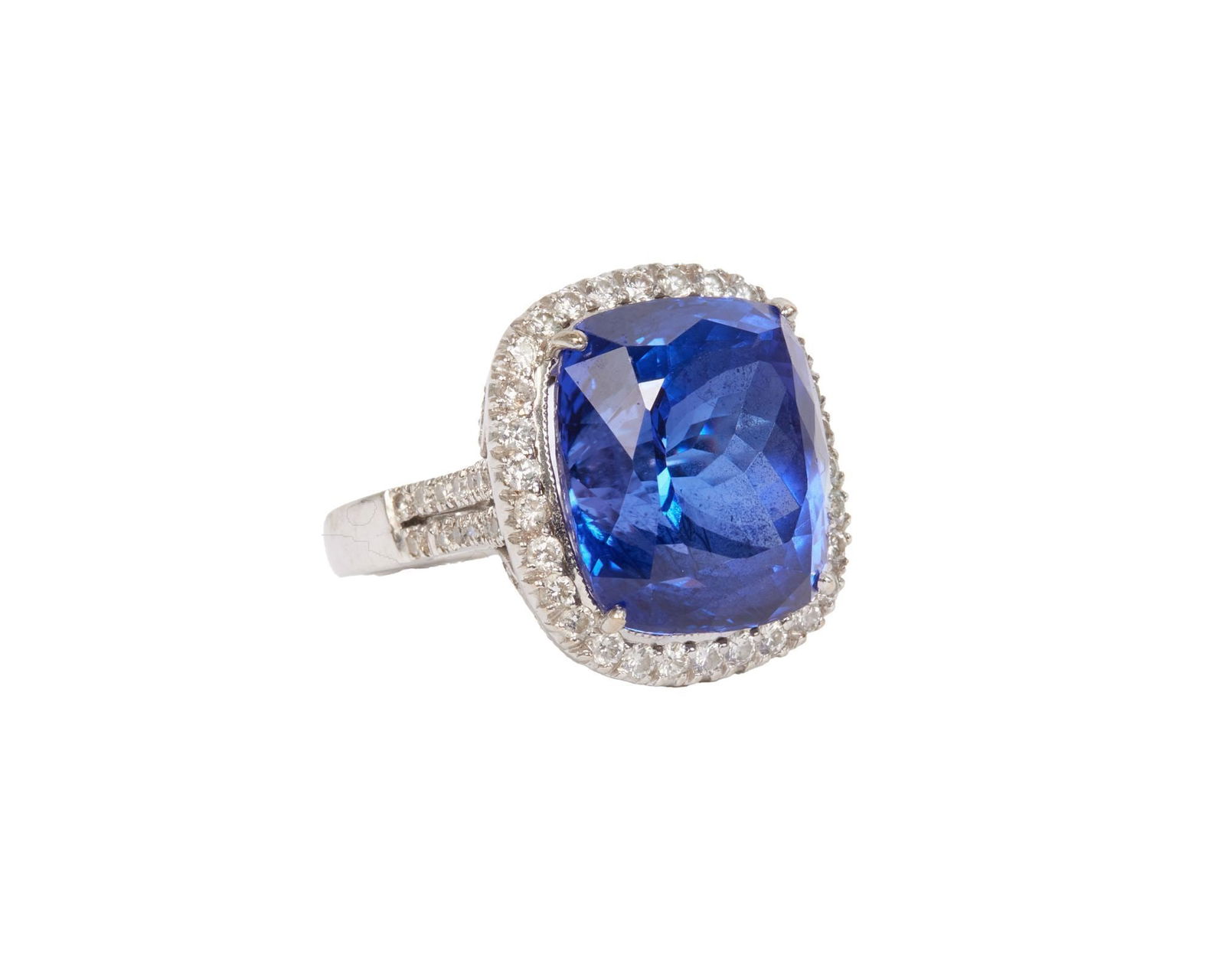 Whoopi Goldberg | 18k White Gold Tanzanite and Diamond Ring: Centering upon a cushion-cut tanzanite measuring 16.2 x 14.2 x 10.5 mm.14.7 grams, ring size 6.25.Marked 18k. Condition: 136 circular-cut diamonds gauged to weigh approximately 1.25 carats total,