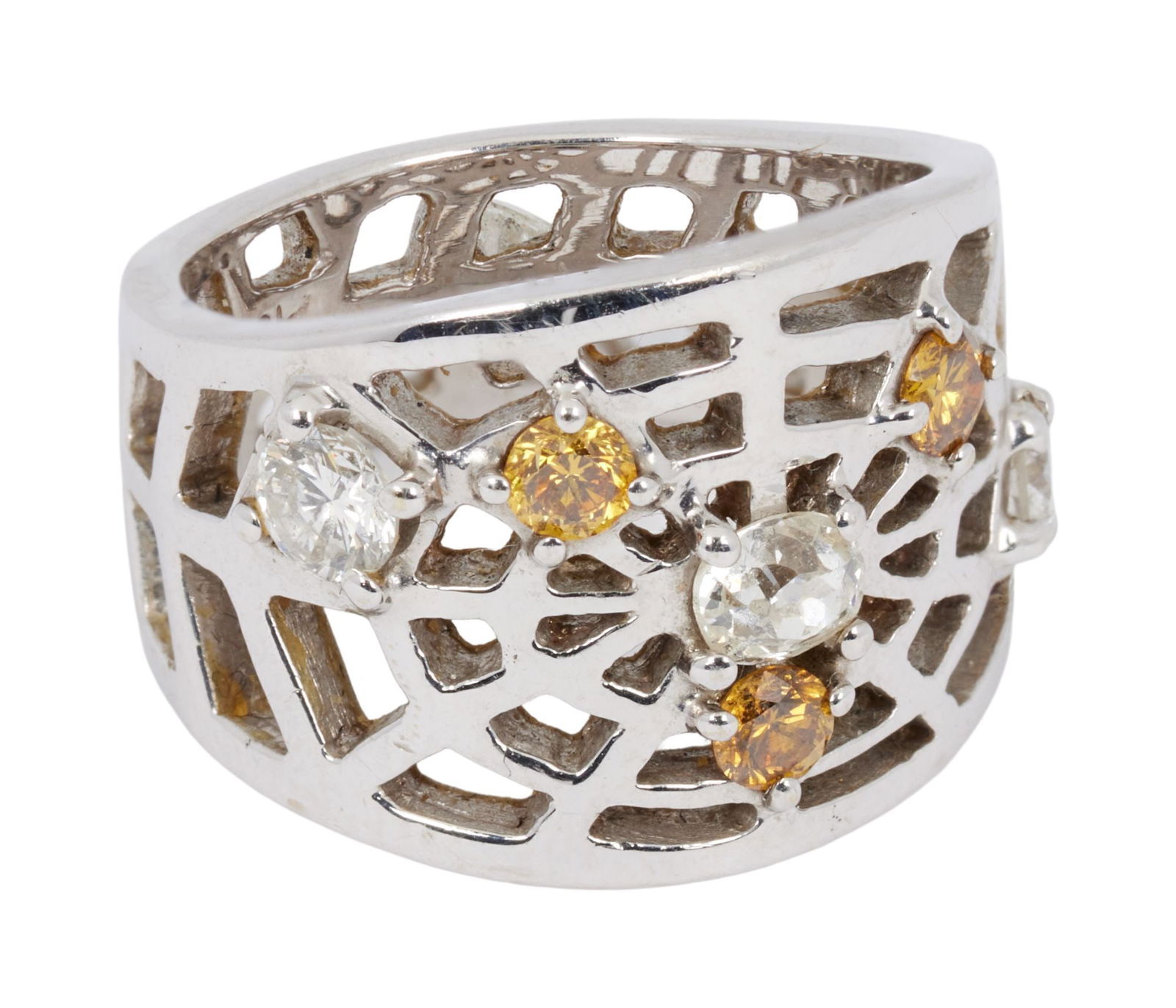 Whoopi Goldberg | 18k White Gold Diamond and Colored Diamond Spider Web Ring Band: The wide 18k white gold openwork band centering upon a spider"?s web design, accented by old European-cut diamonds and circular-cut yellow diamonds, 10.4 grams, ring size 7.25.With jeweler"?s mark.Con