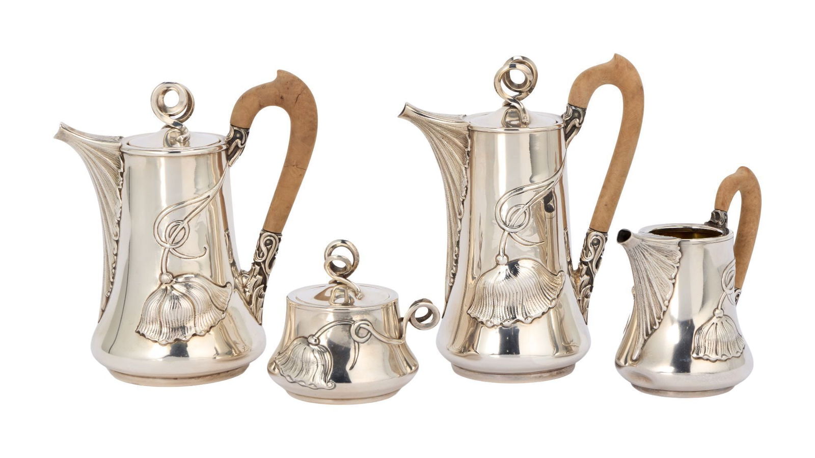 Whoopi Goldberg | Buccellati Four-Piece Sterling Tea Service: An Art Nouveau style four piece tea service featuring stylized flowers with sinuous foliage winding into curled finials with natural wood handles. Marked "Buccellati Italy 925" on the unders