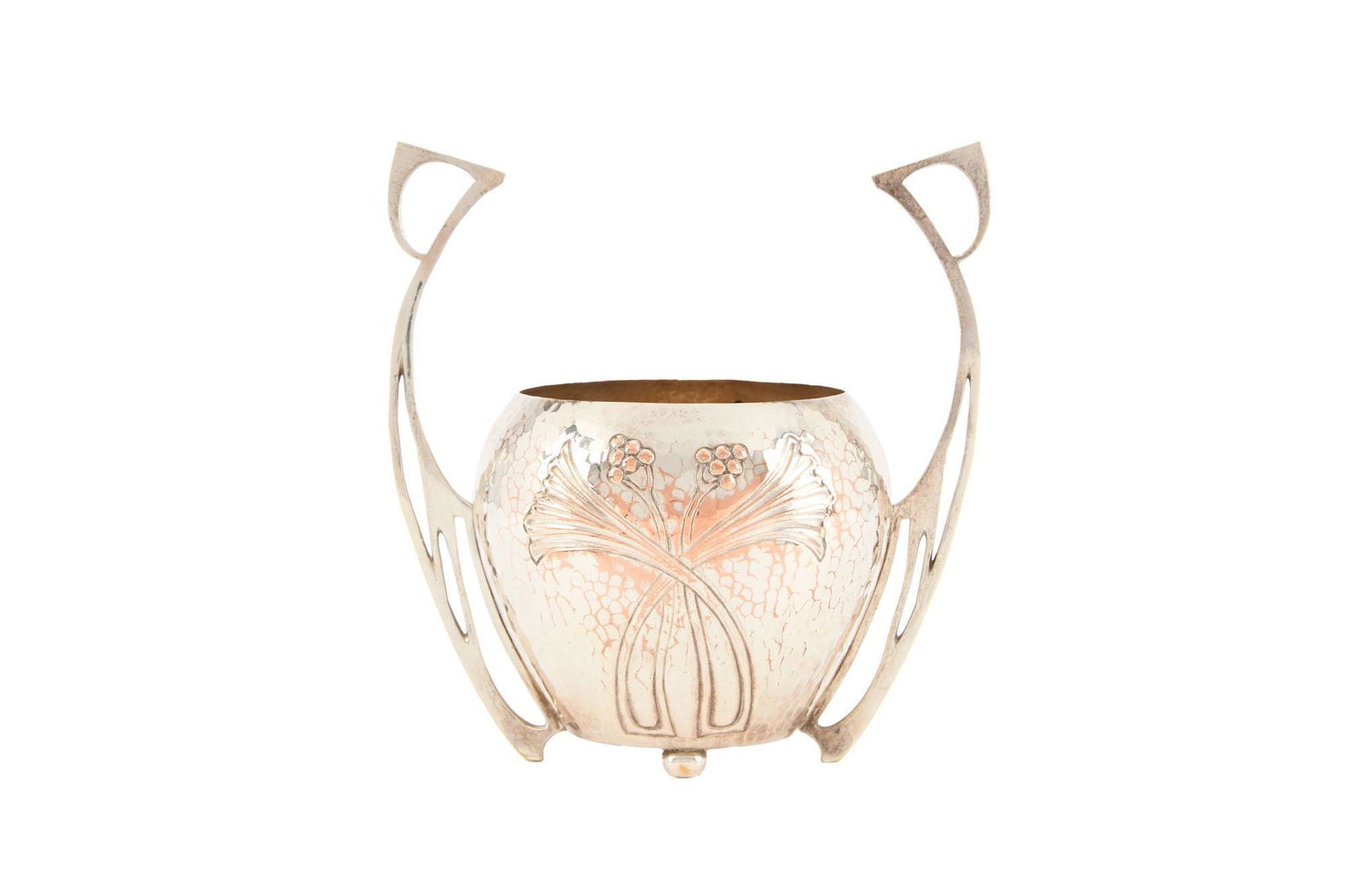 Whoopi Goldberg | WMF Art Nouveau Hammered Metal Jardiniere: An Art Nouveau hammered metal jardiniere with upswept angular handles and incised and applied floral decoration. 9 x 9.5 x 6 inches From the Collection of Whoopi Goldberg