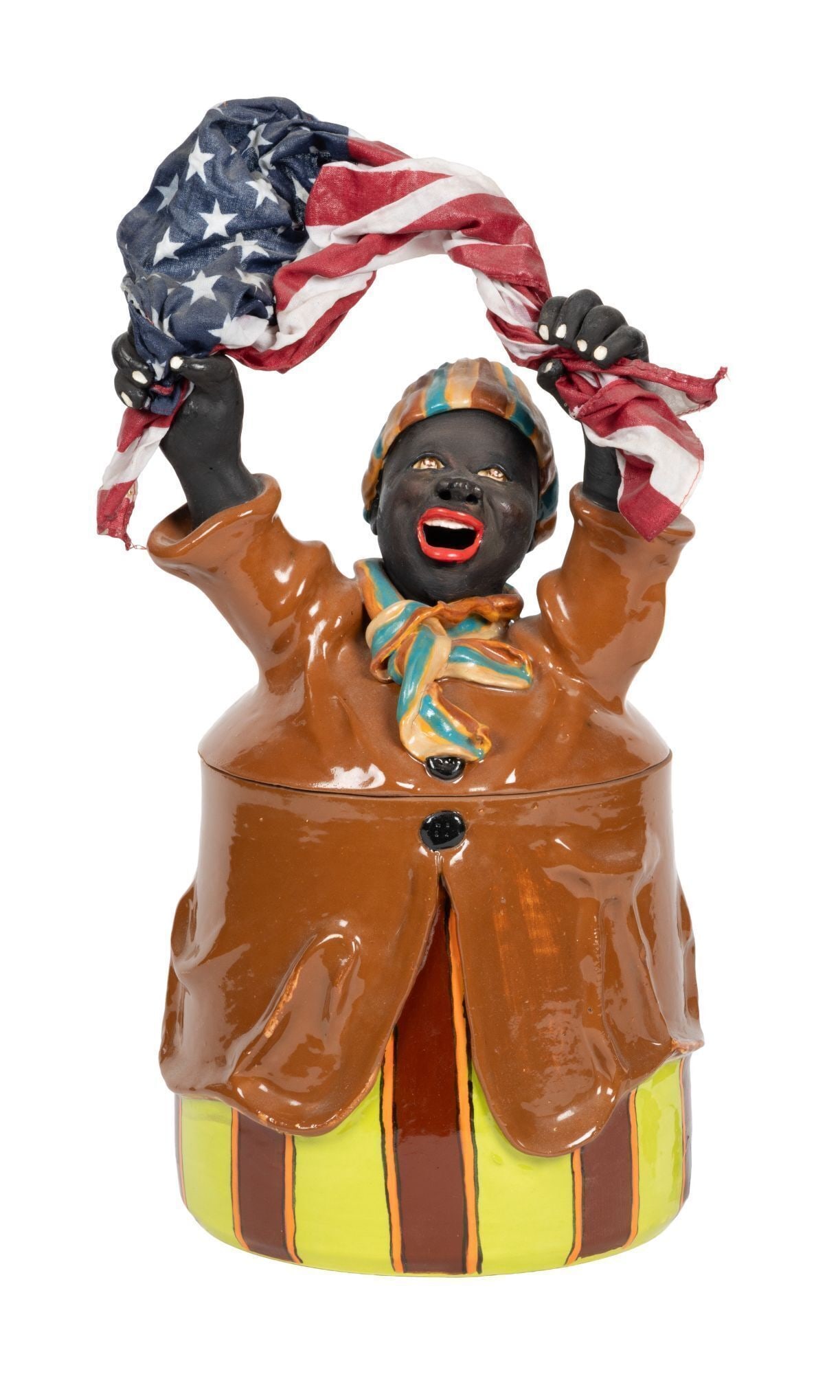 Whoopi Goldberg | Tracy Ameen Ceramic Cookie Jar with Flag: A polychrome painted ceramic figural cookie jar depicting an African American woman lifting an American flag over her head. Created in tandem with the election and inauguration of President Obama in 2