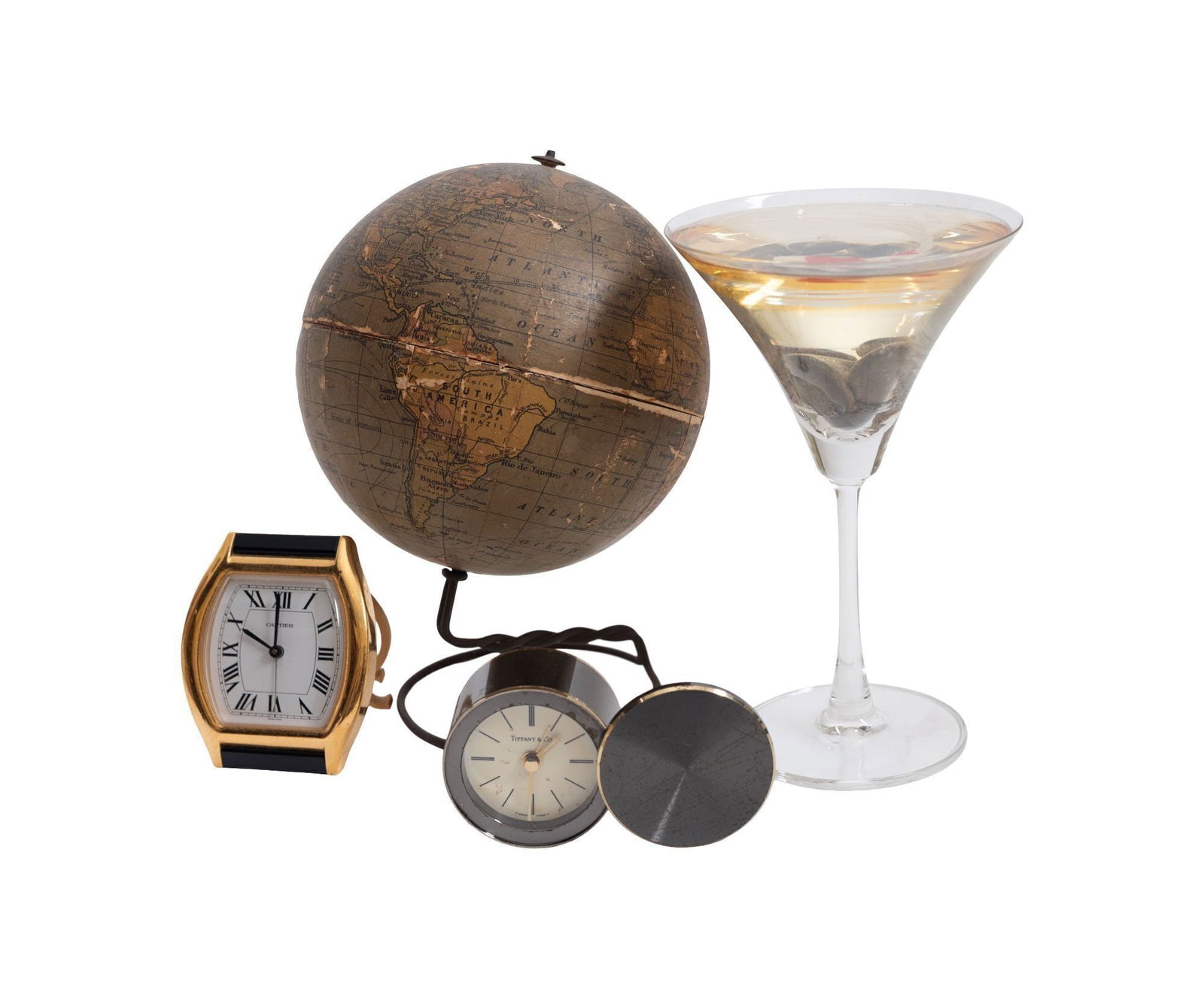 Whoopi Goldberg | Four Assorted Decorative Items: A group of four items, including a Cartier desk clock, a Tiffany & Co. desk clock, a resin martini glass with a koi fish inside, and a vintage globe. Please note: the clocks are not guaranteed to be o