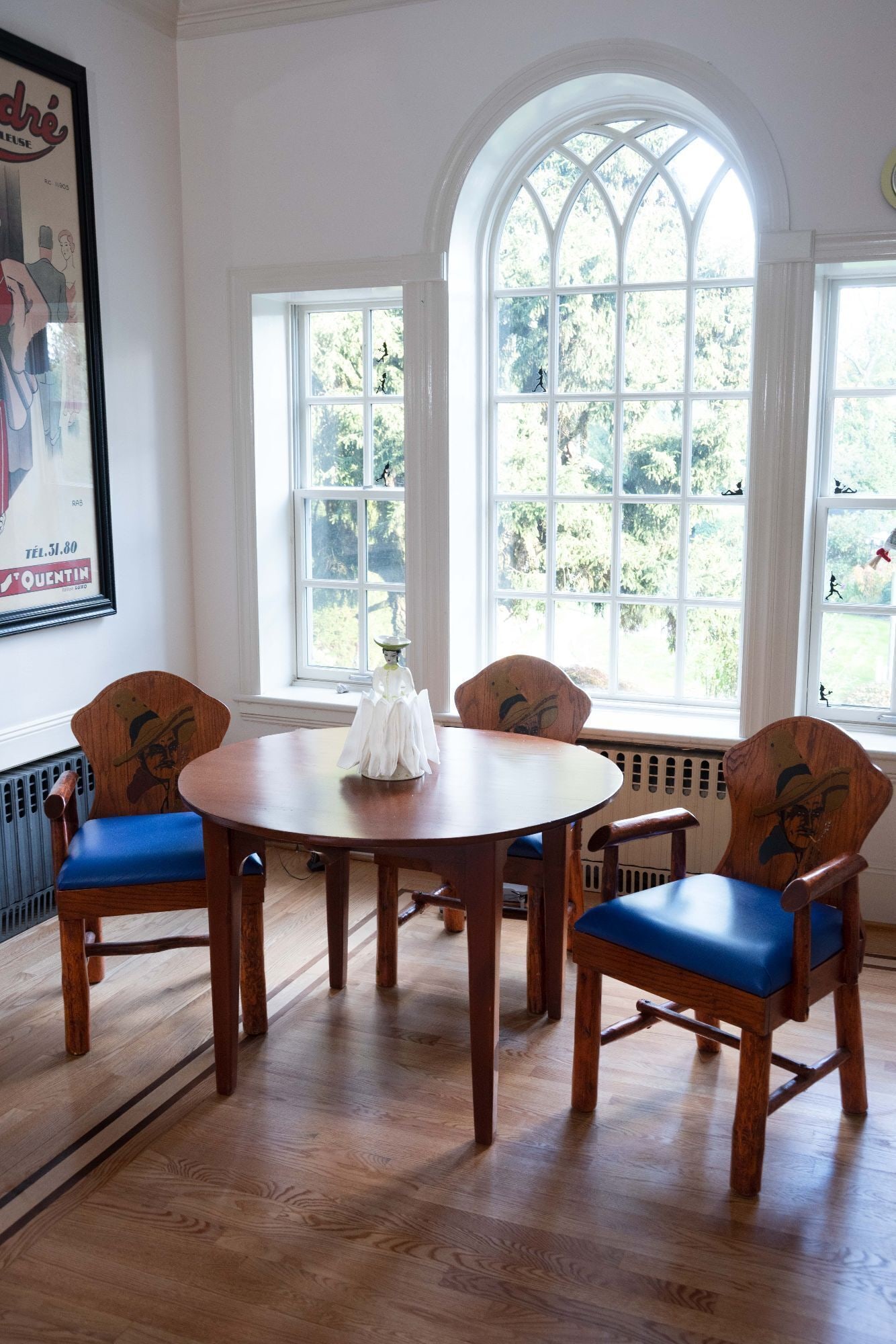 Whoopi Goldberg | Vintage Molesworth Style Wyoming Furniture Kitchen Table and Chairs: A vintage 1950s Western style oak dining set with keyhole shaped routed and stained cowboy armchairs, vinyl seat upholstery, and log-form legs. In the style of Thomas Molesworth. Table 29 x 42 inches;